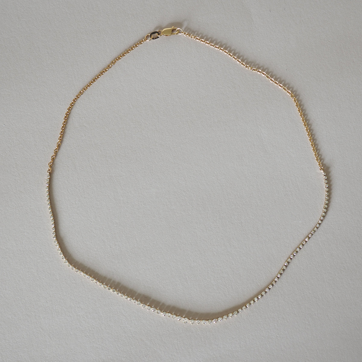 Gold chain necklace on a light background, featuring a simple yet elegant design, ideal for luxury jewellery enthusiasts.