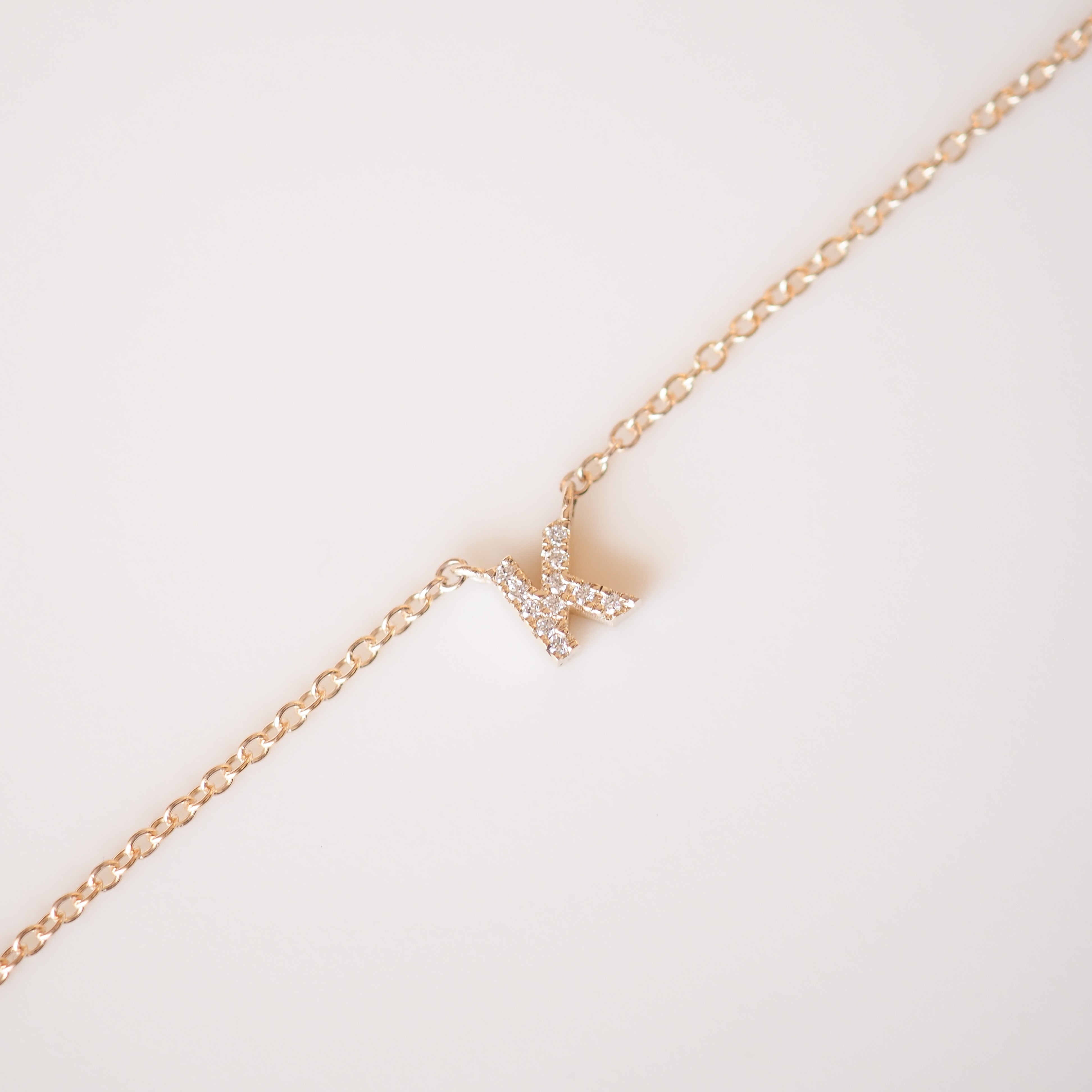 Gold diamond letter necklace on a cable chain