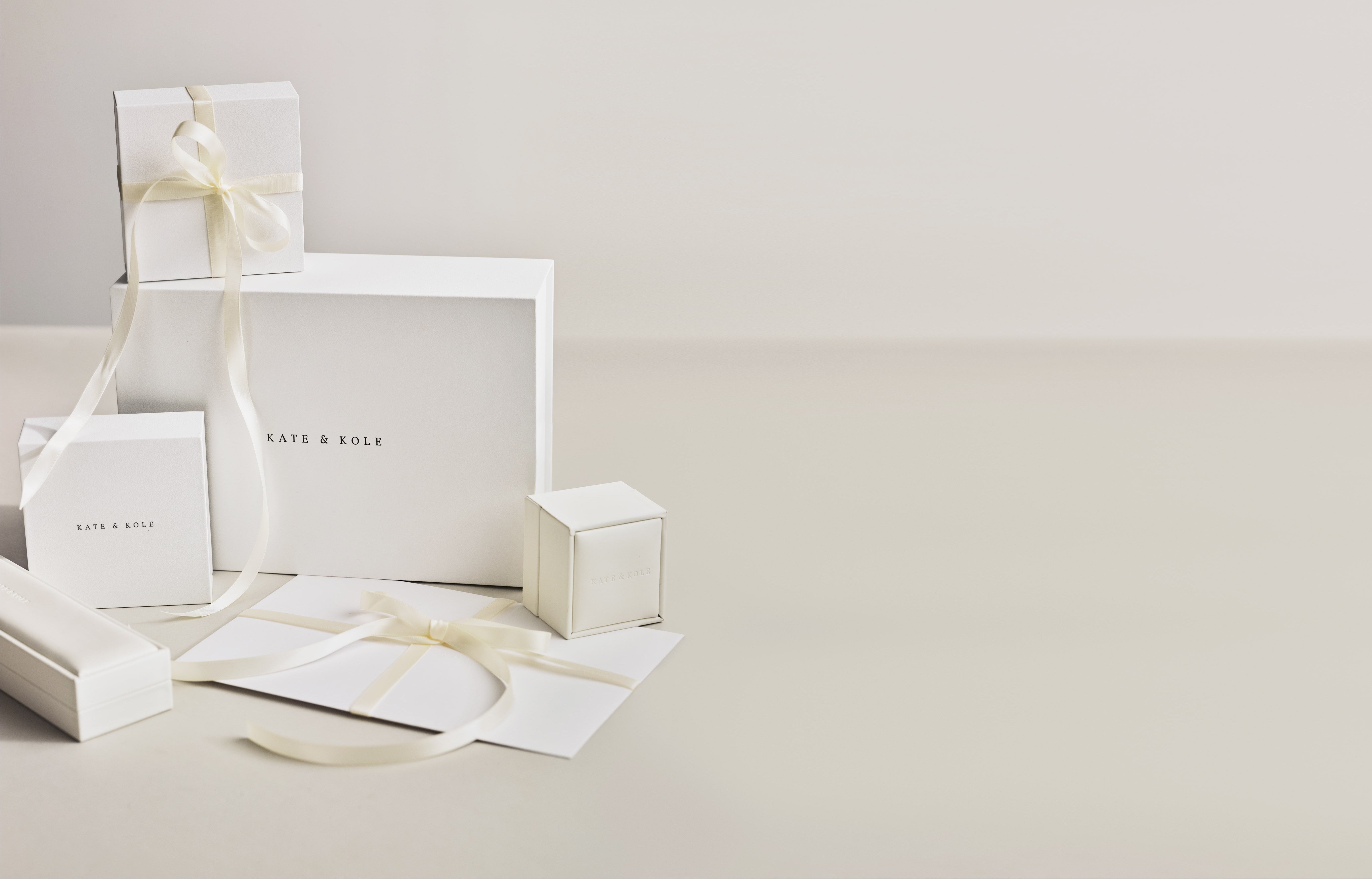 Kate & Kole gift packaging and white boxes, displayed on a white background.