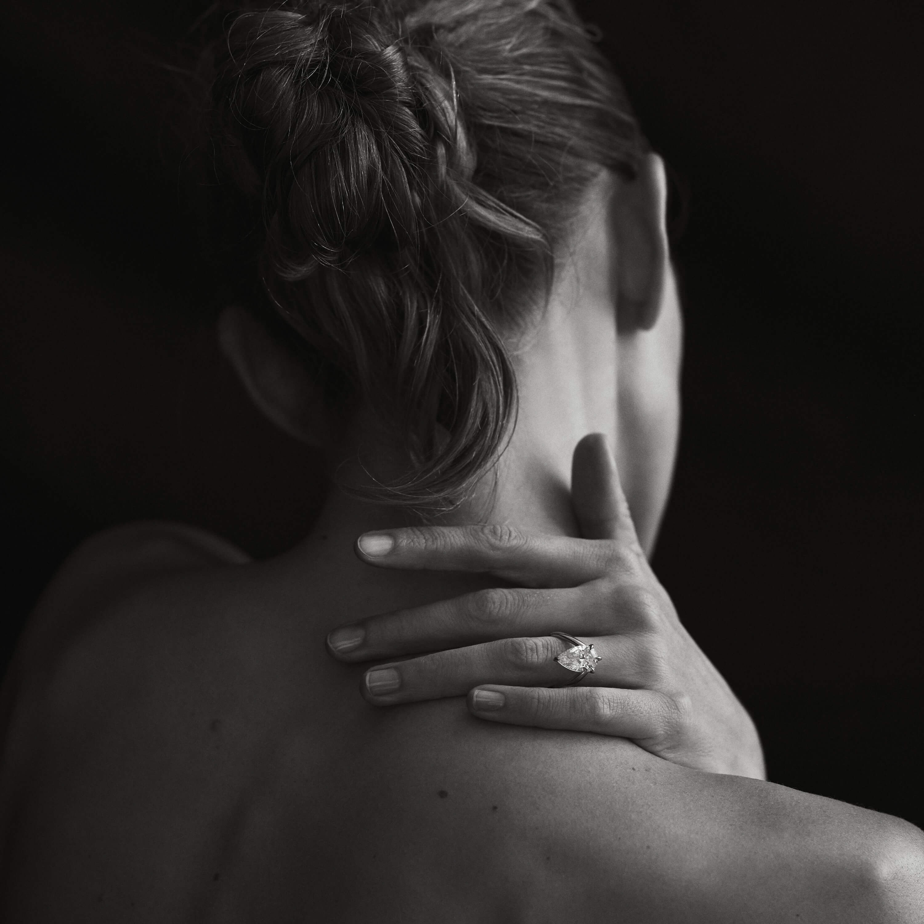 Kate & Kole diamond ring on hand, worn on the shoulder.