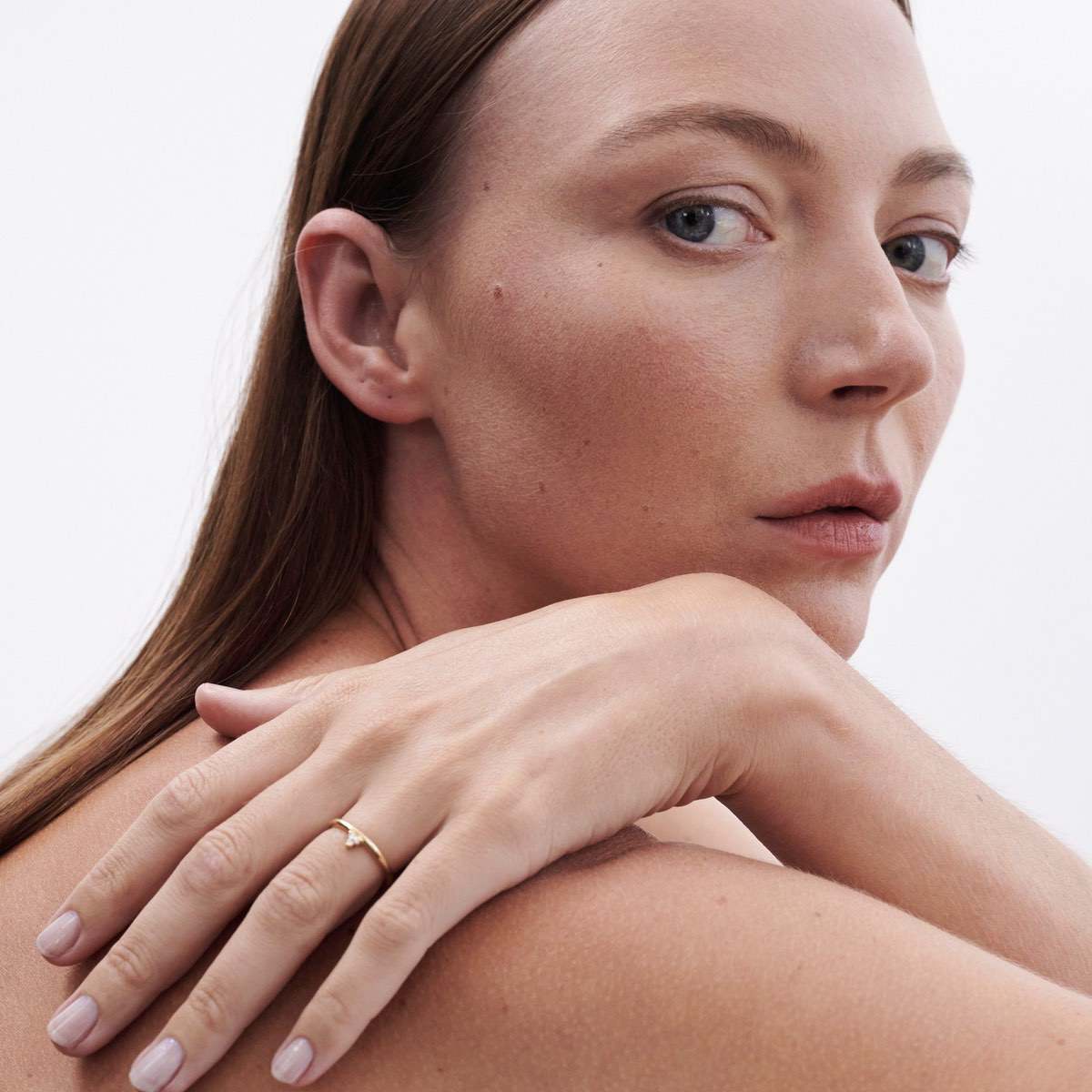 Model wears Therefore Ring with offset 3 stone cluster setting with lab grown diamonds in 9ct Yellow Gold