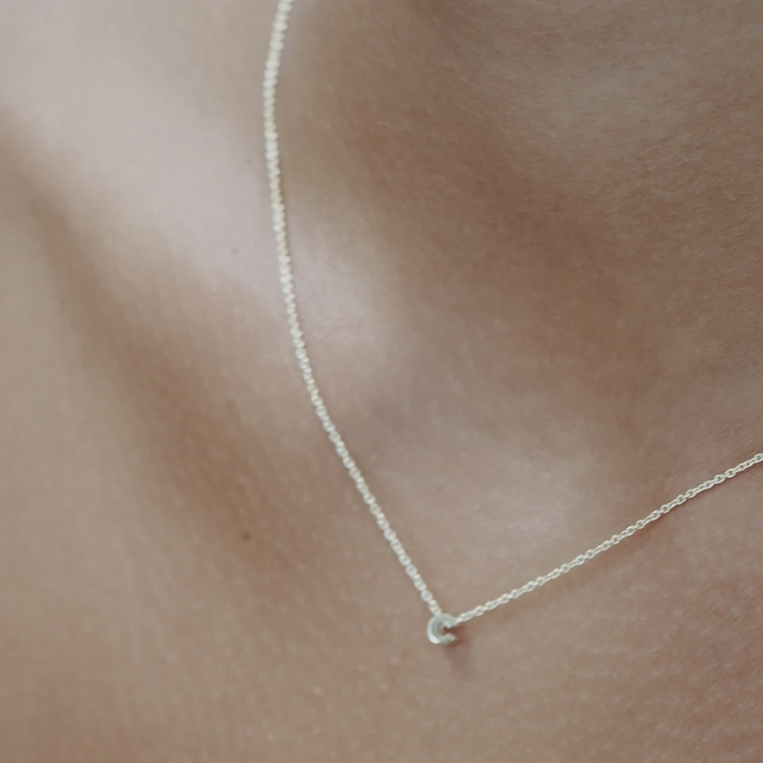 Solid gold and sterling silver jewellery: Video of a model wearing our signature sterling silver tiny letter C charm necklace on a 40cm cable chain
