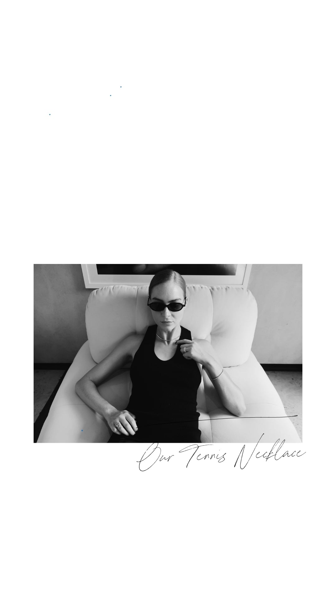 Woman in sunglasses reclines on a white sofa, wearing a sleek black outfit and elegant tennis necklace. Text reads "Our Tennis Necklace."