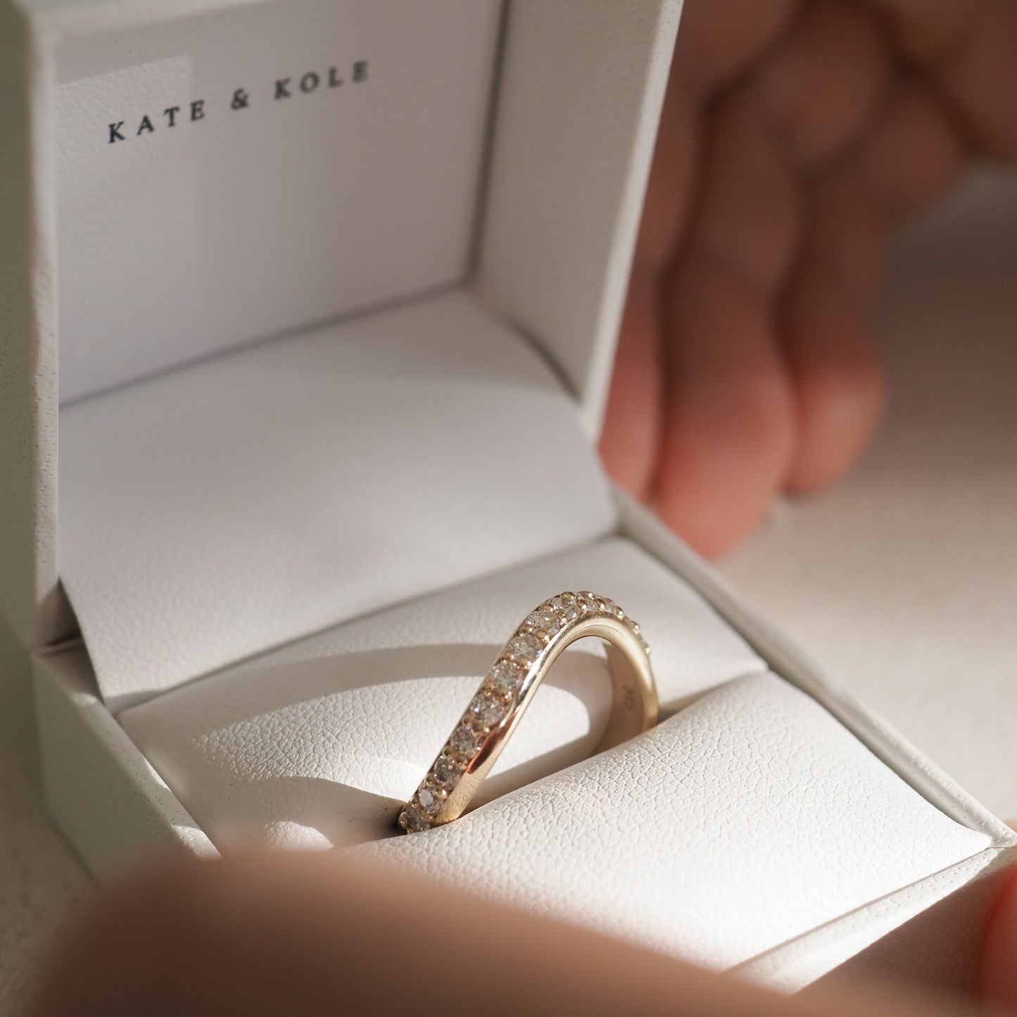 Gold diamond ring in a Kate & Kole jewellery box, with soft lighting highlighting the elegant design.