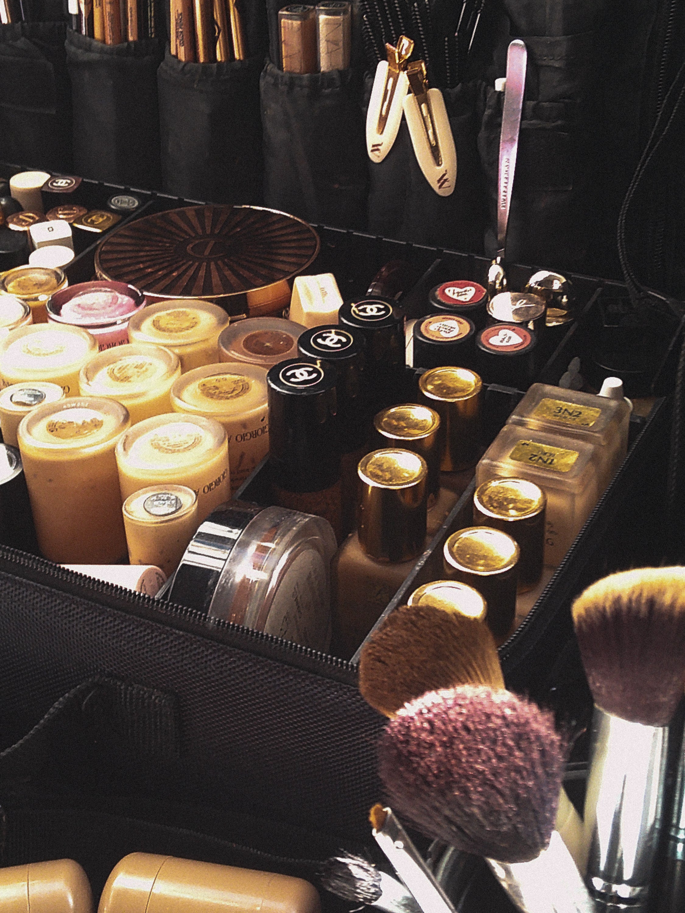 Makeup kit with luxury brand cosmetics, foundations, lipsticks, and brushes neatly organised. Perfect for high-end beauty enthusiasts.