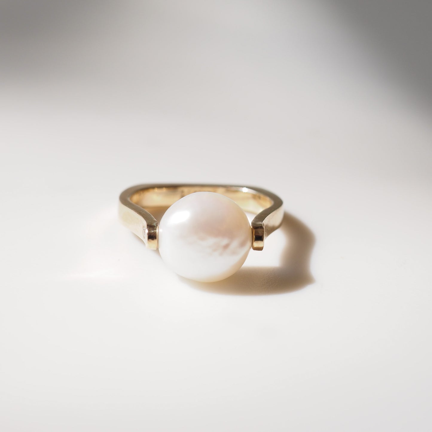 Pearl ring on light grey background
