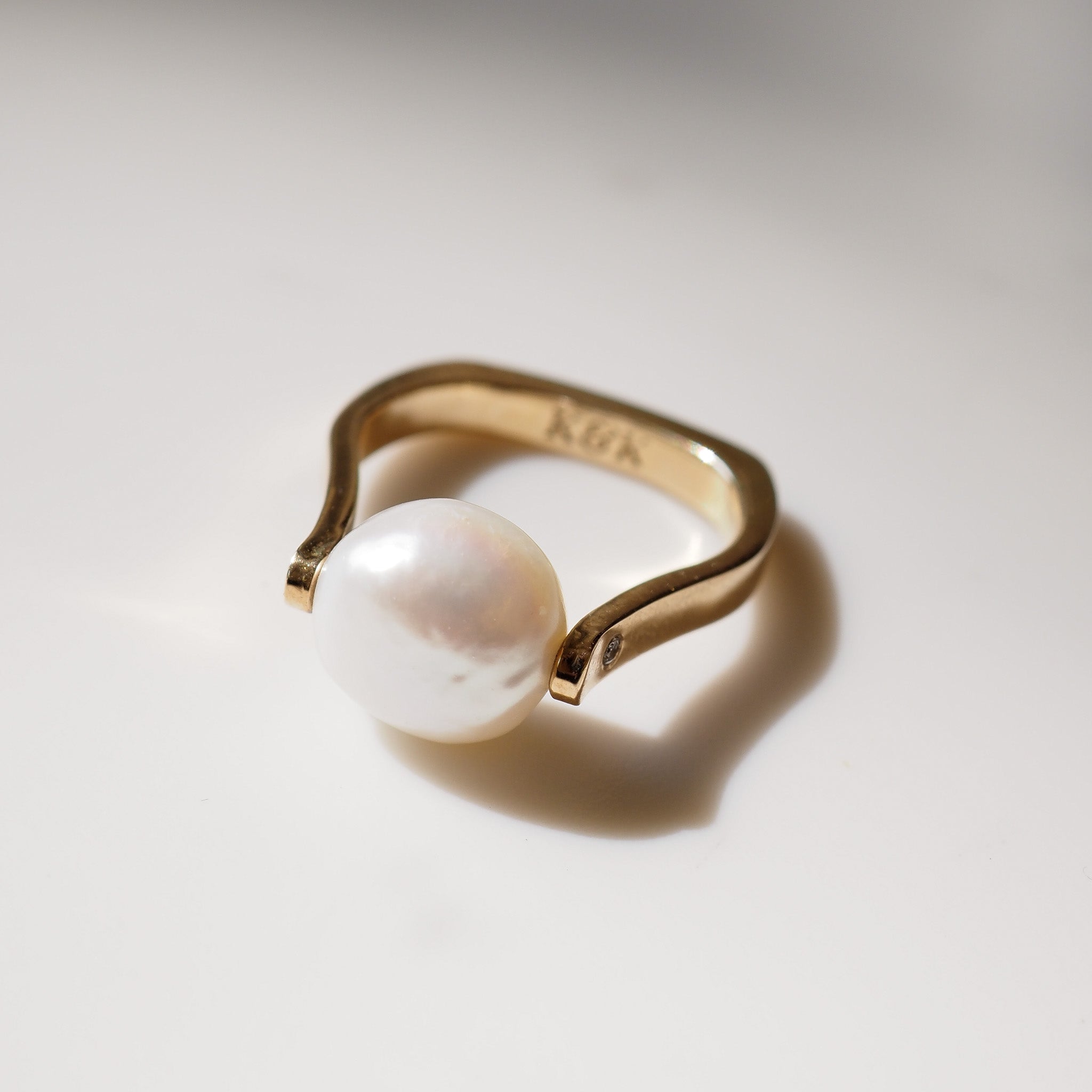 Pearl ring on light grey background