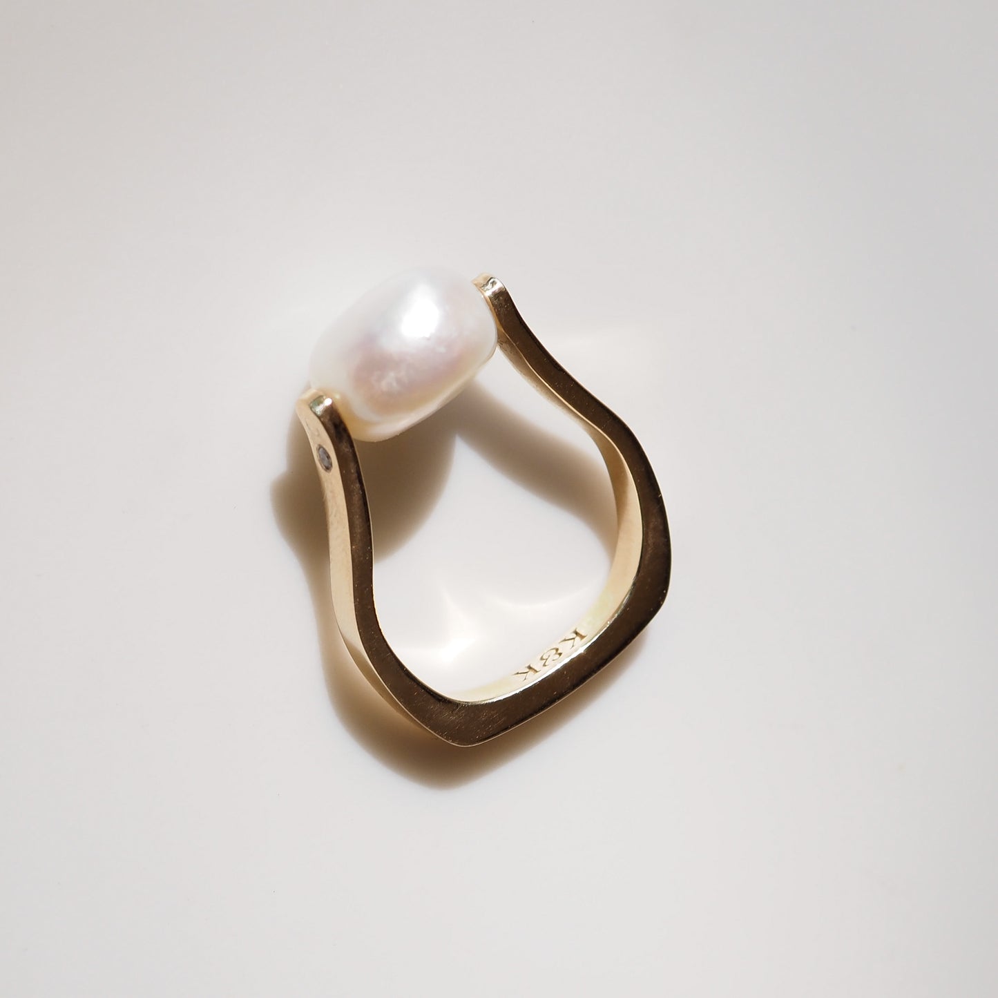 Pearl ring on light grey background