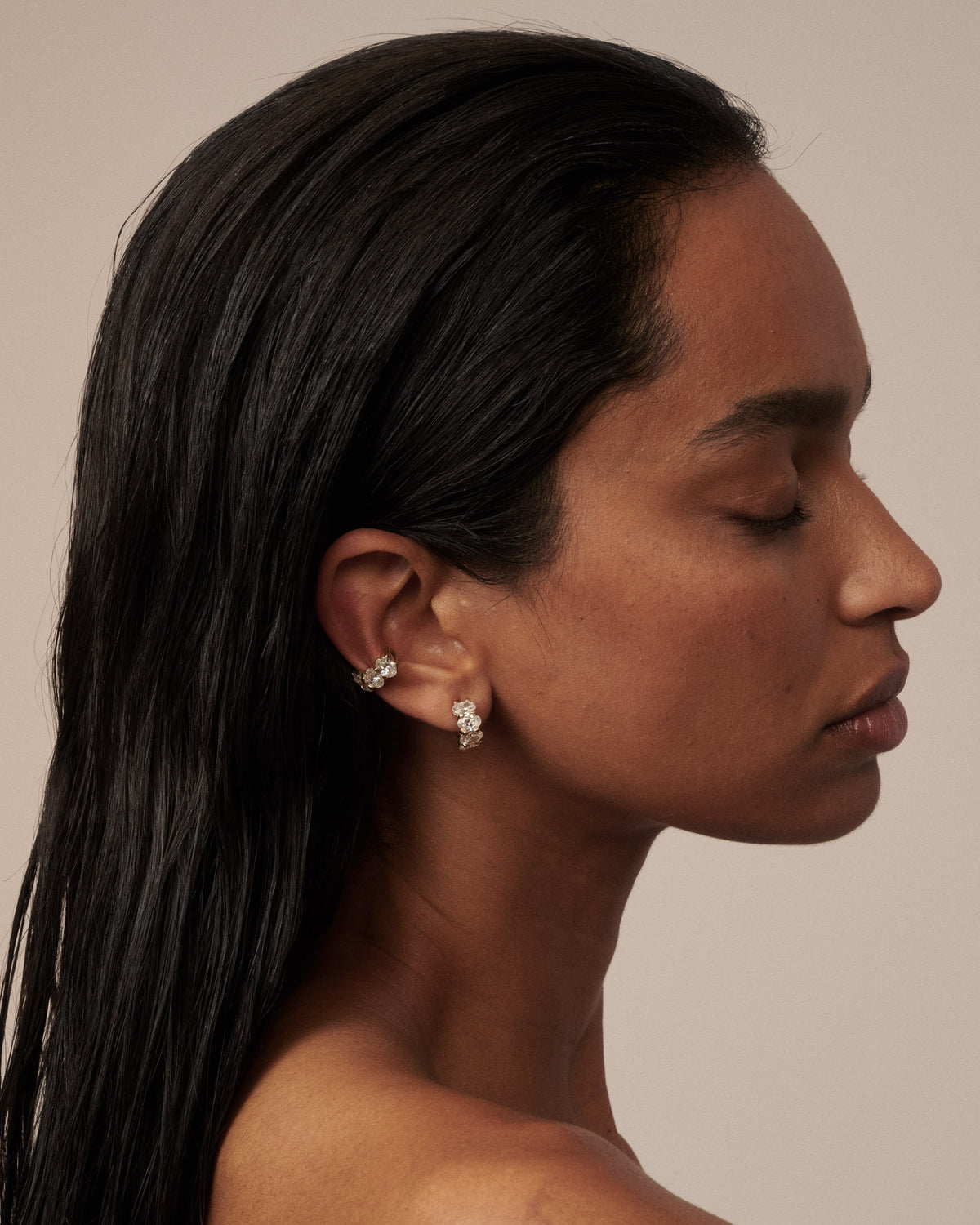 Gold oval lab-grown diamond ear cuff and stud earrings, side view on model