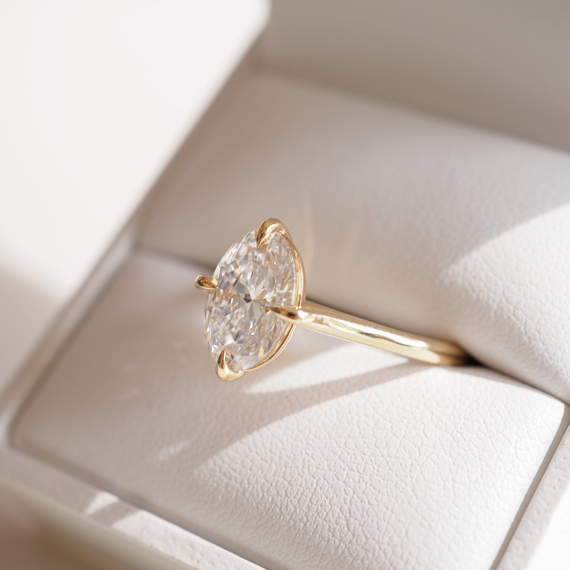 Marquise diamond ring with gold band in a white jewellery box, showcasing luxury and elegance in fine Australian jewellery design.