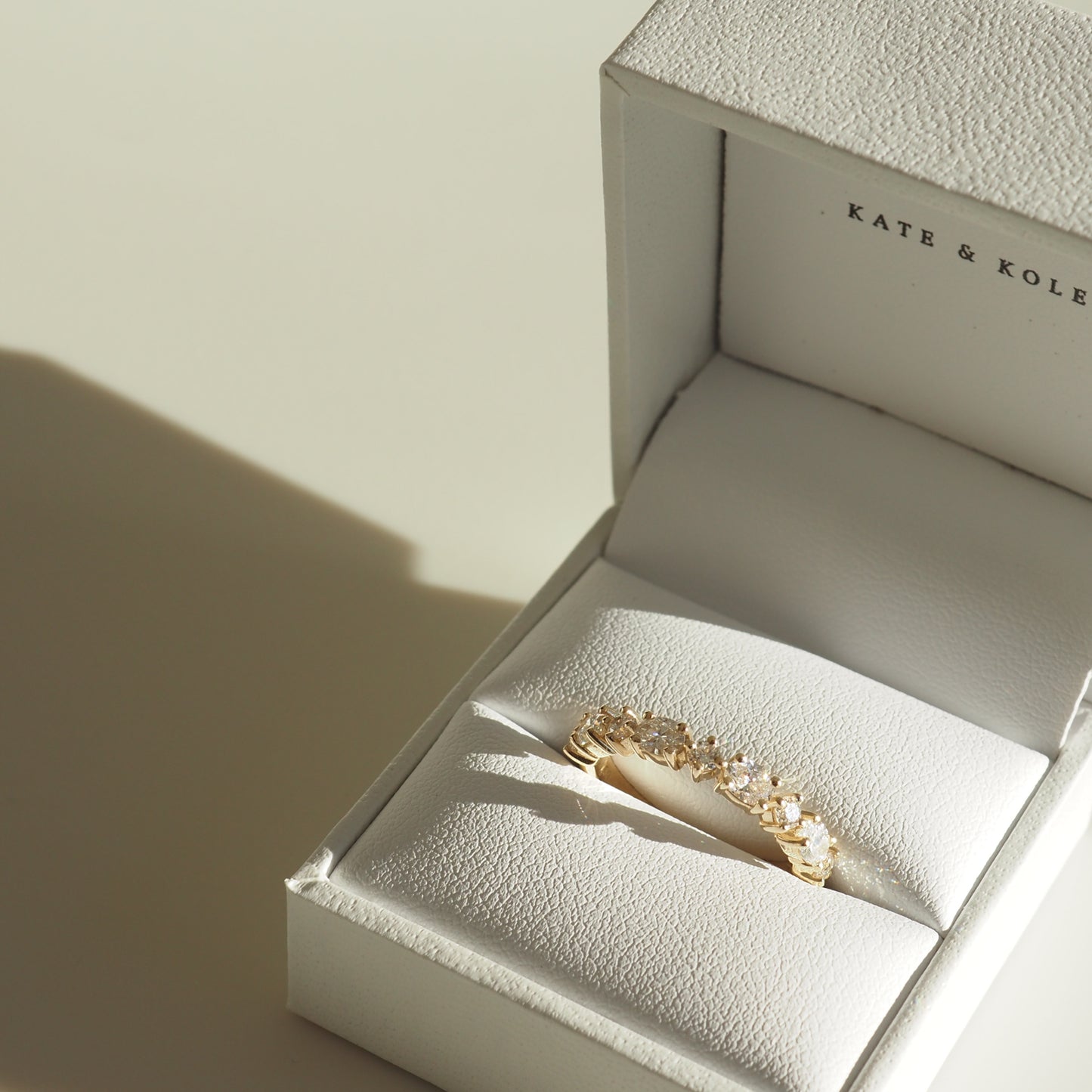 Gold diamond ring in a white jewellery box with elegant interior. Ideal for an engagement or special occasion.