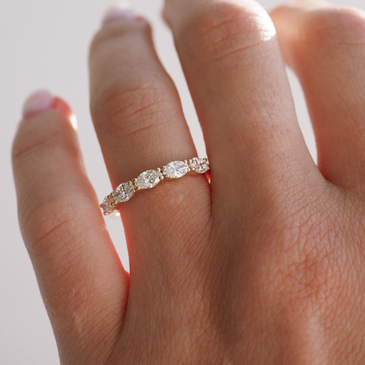 Elegant diamond-studded gold ring on hand with soft-focus background; luxury jewellery, Australian design, engagement inspiration.