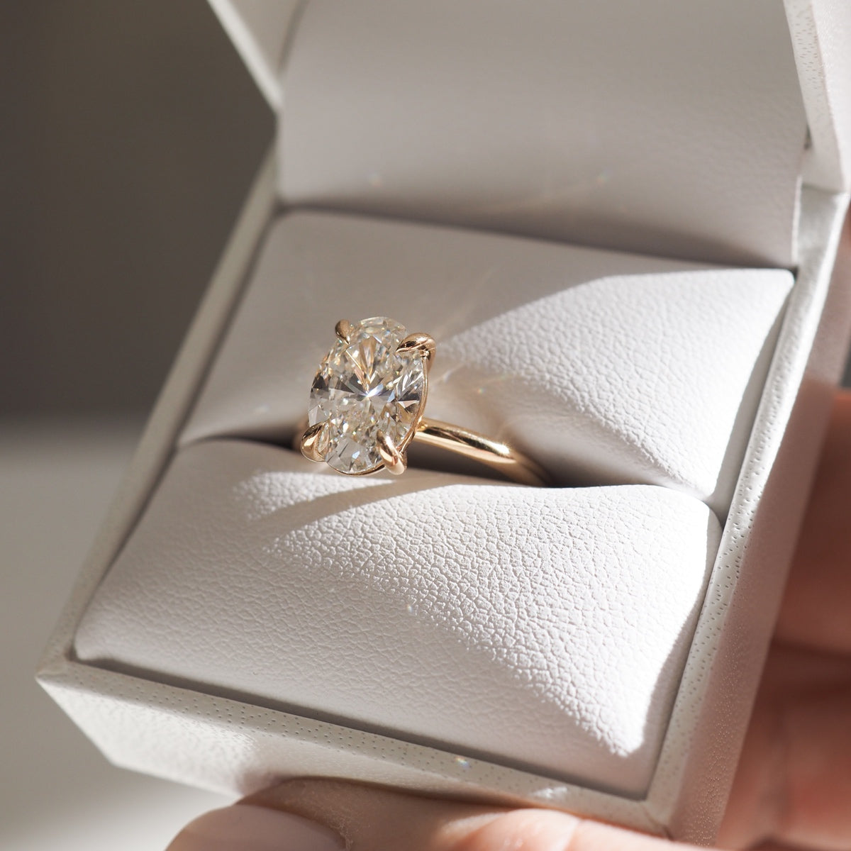 Clara showcases the timeless beauty of a 2.61ct oval lab-grown diamond. 4 claw setting in solid 18ct yellow gold. 