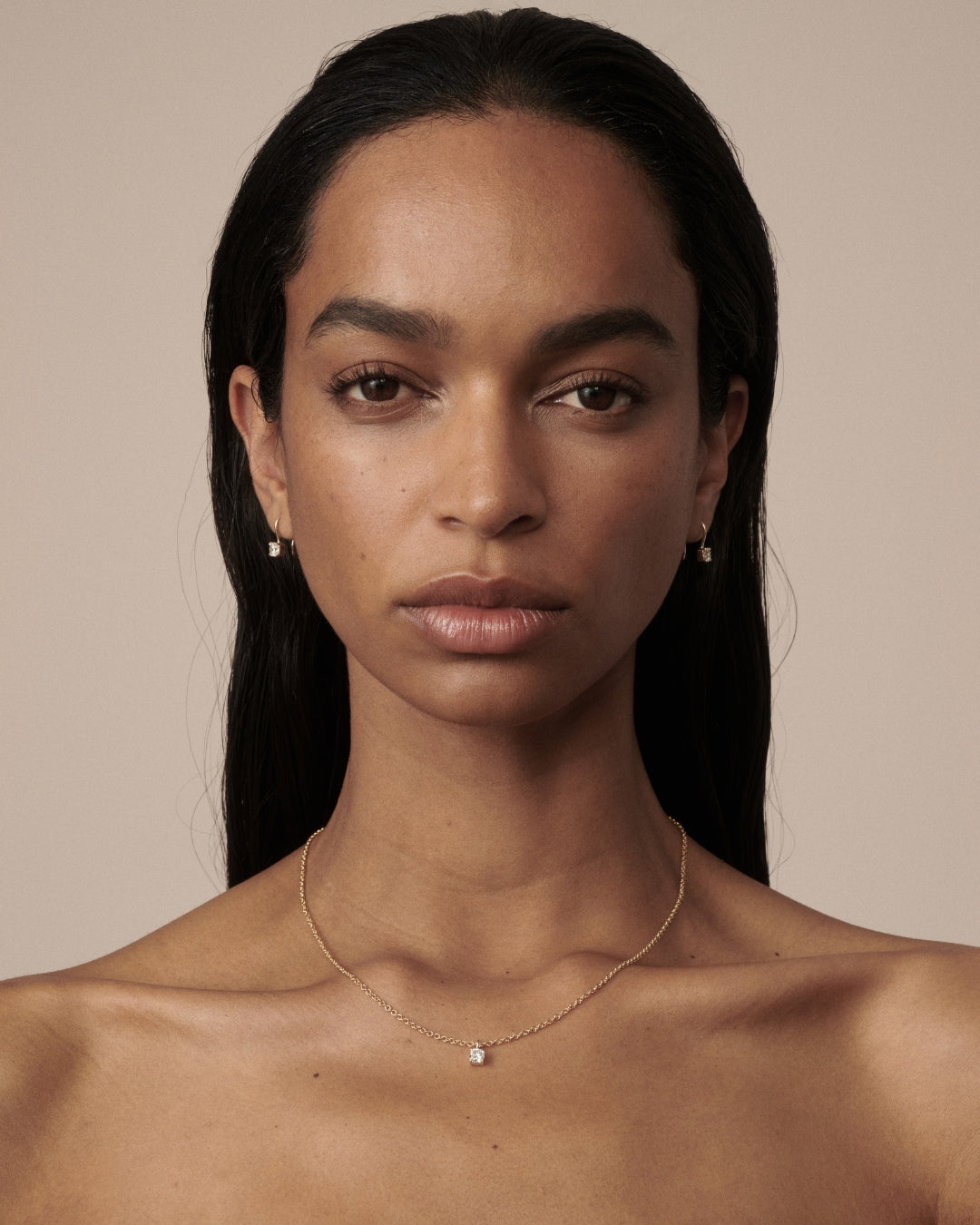 Cushion Pendant as worn by model Franciele shot on a light beige background