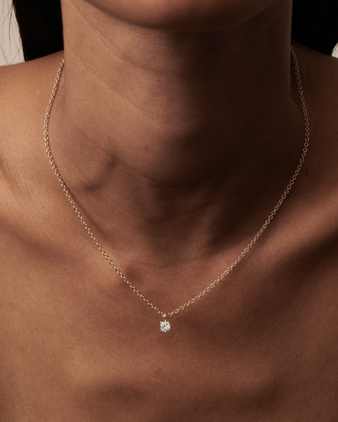 Cushion Pendant as worn by model Franciele shot on a light beige background