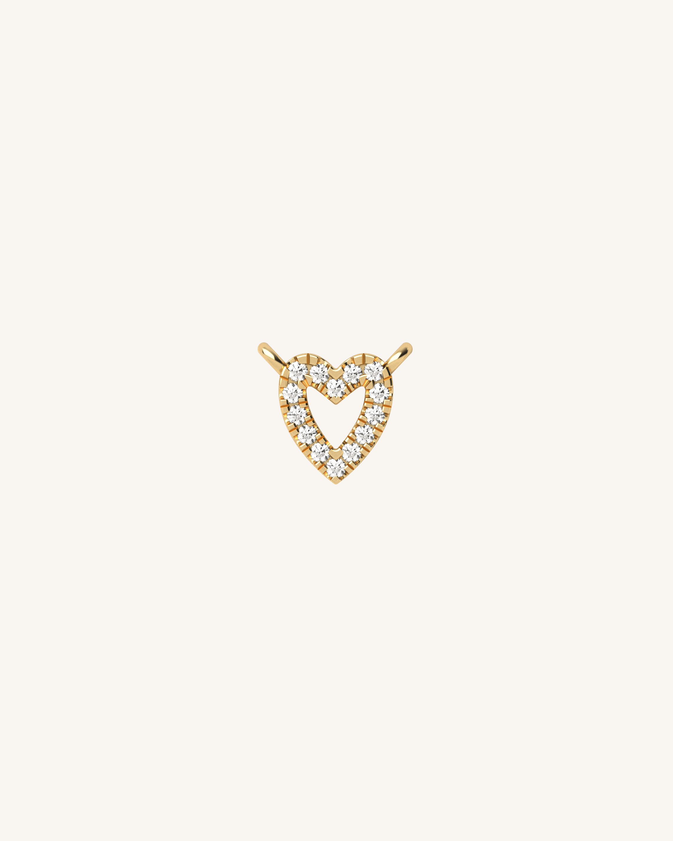 Pair of yellow gold diamond heart charm on a white background