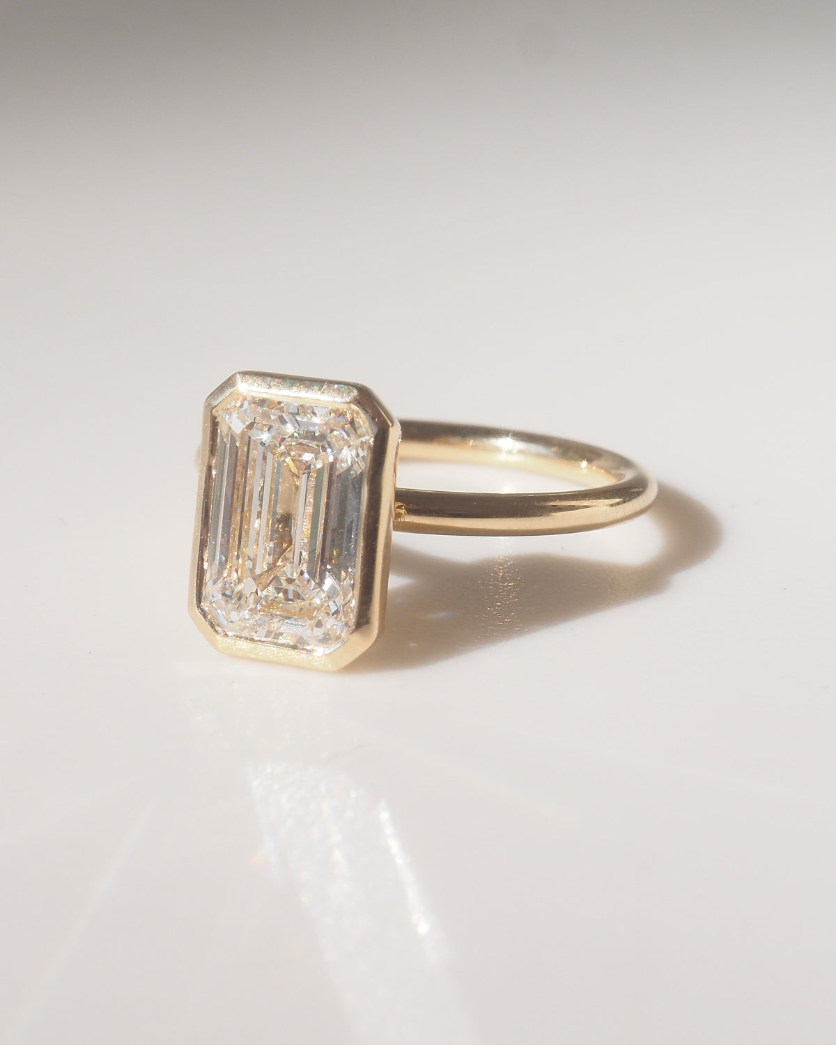 Emerald diamond ring on a gray background