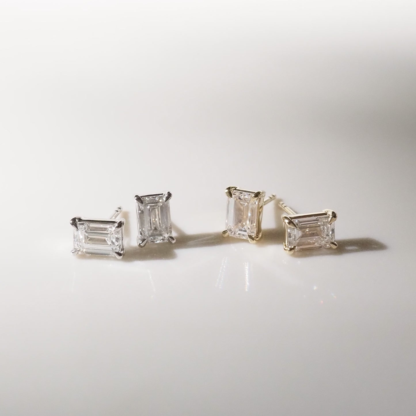 Pair of diamond earrings on a light gray background