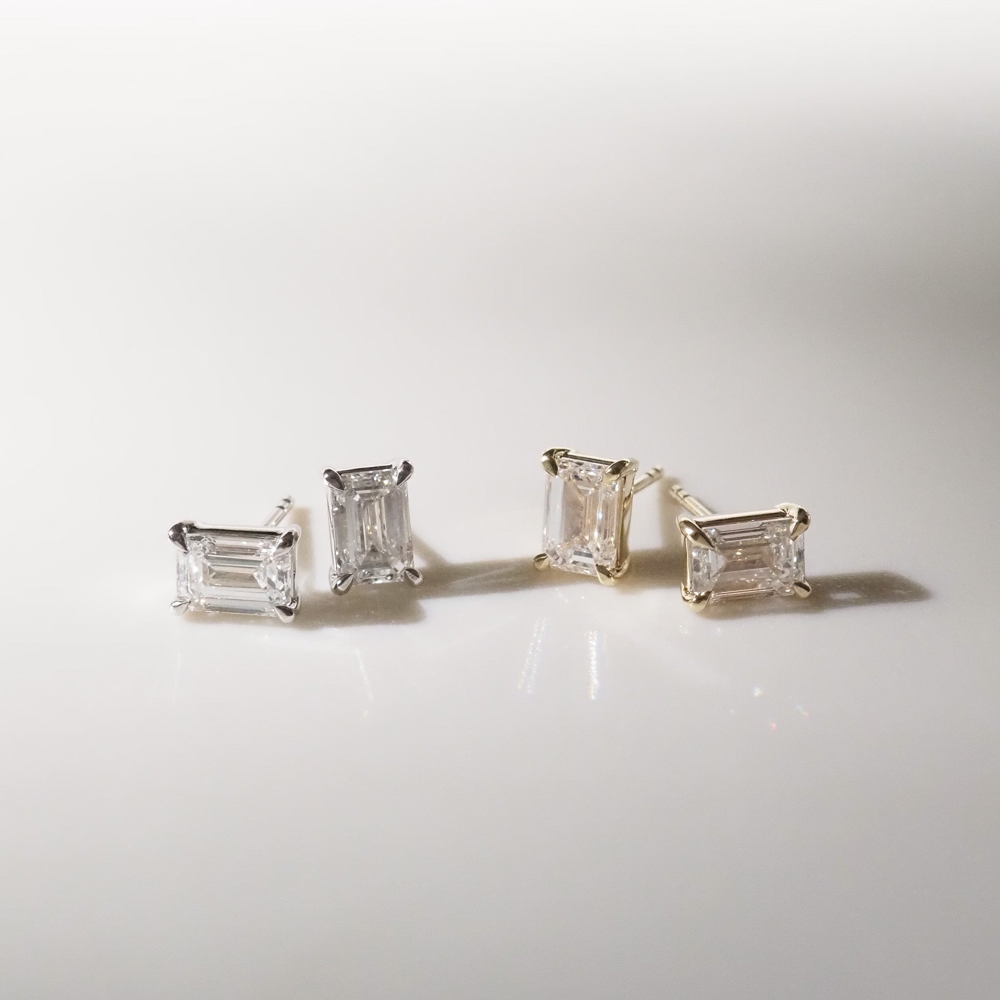 Pair of diamond earrings on a light gray background