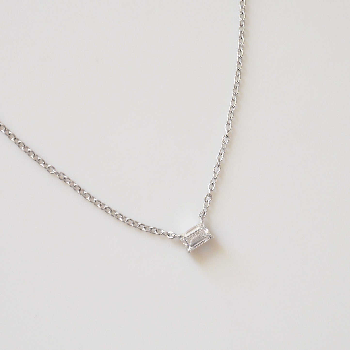 Emerald cut diamond pendant necklace detail