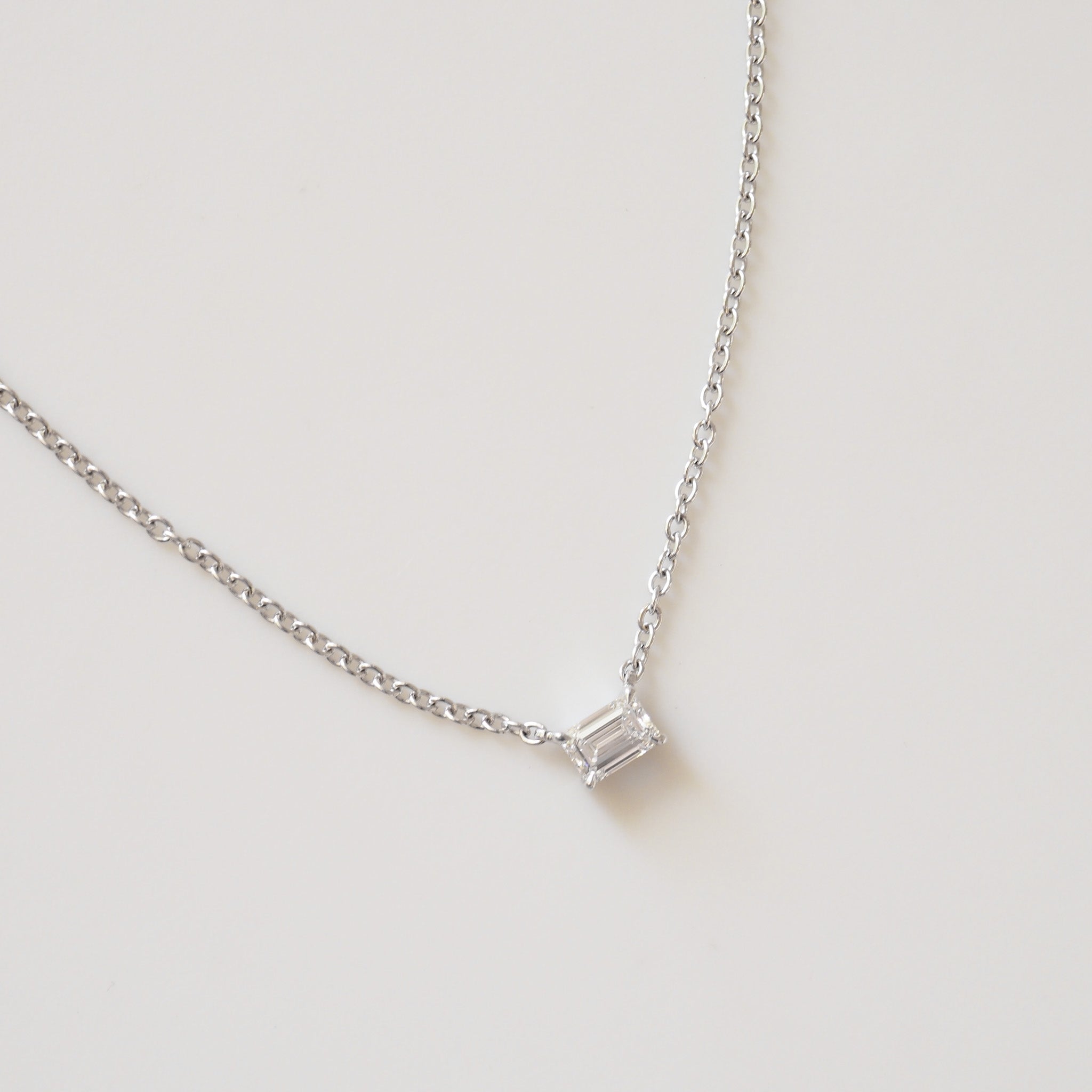 Emerald cut diamond pendant necklace detail