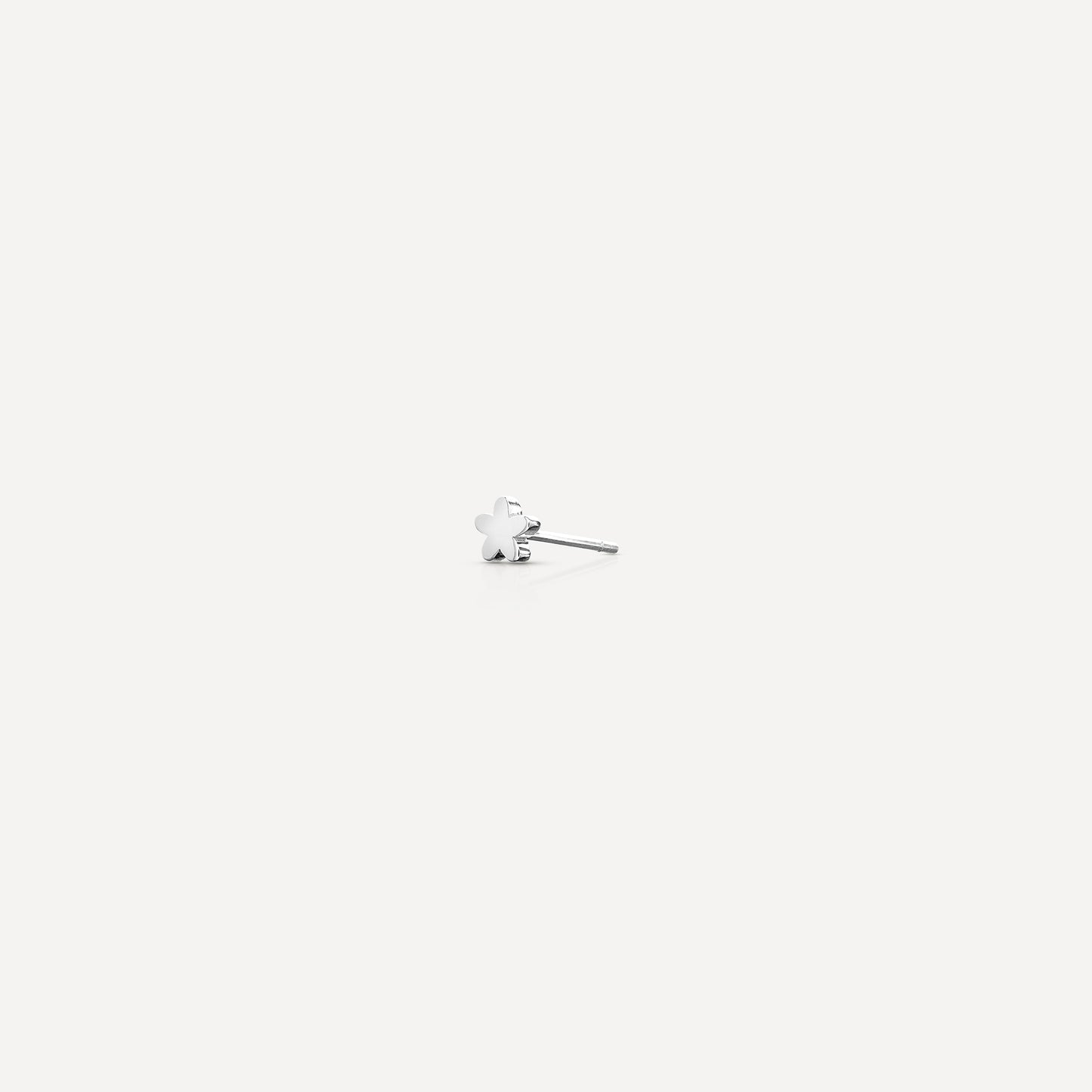 Elegant white gold clover stud earring on a light background, highlighting luxury fine jewellery design.