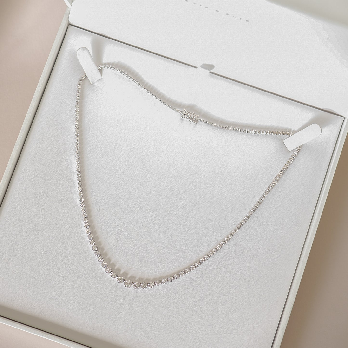 Elegant diamond necklace displayed in an open luxury jewellery box, highlighting its sparkling brilliance, ideal for high-end accessories lovers.