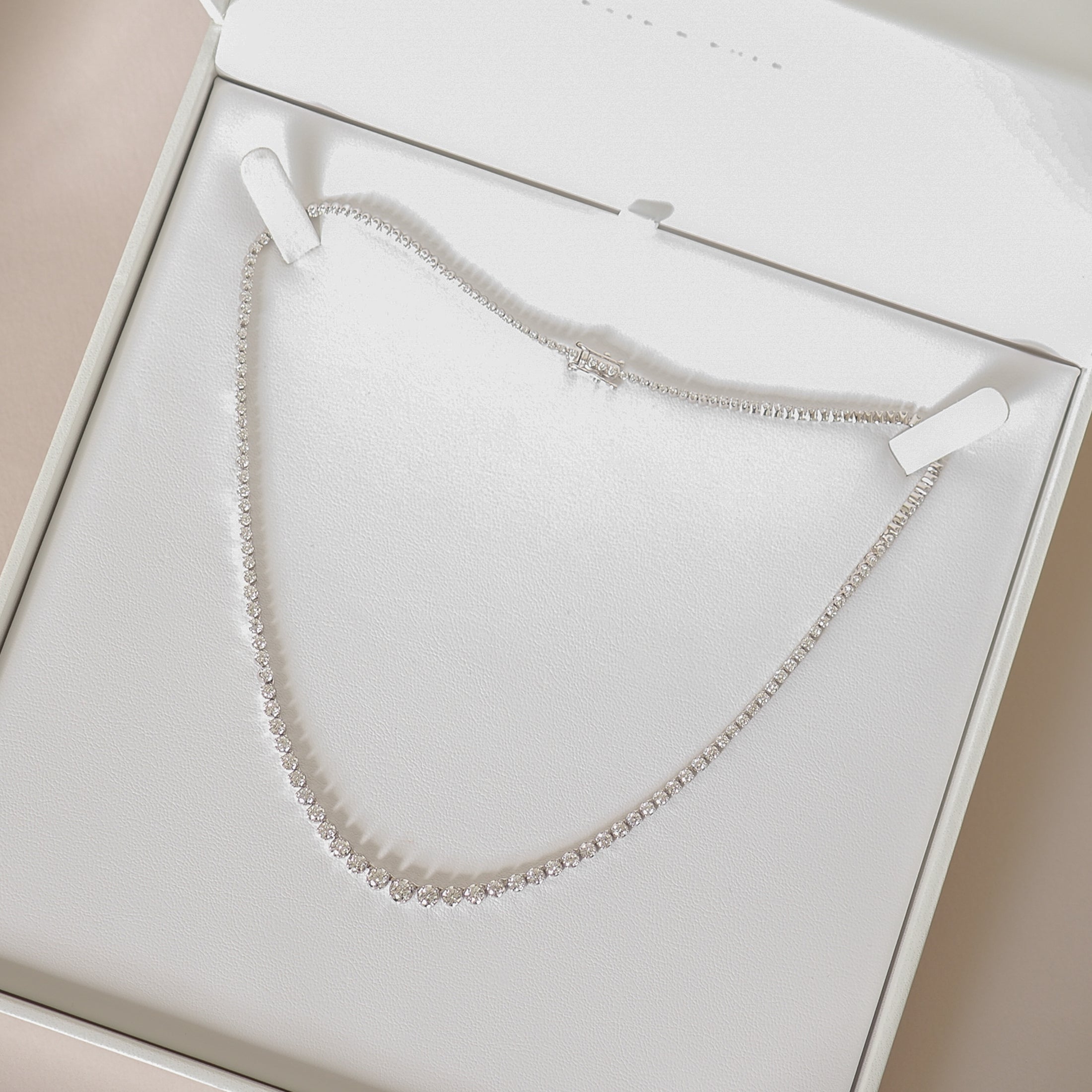 Elegant diamond necklace displayed in an open luxury jewellery box, highlighting its sparkling brilliance, ideal for high-end accessories lovers.