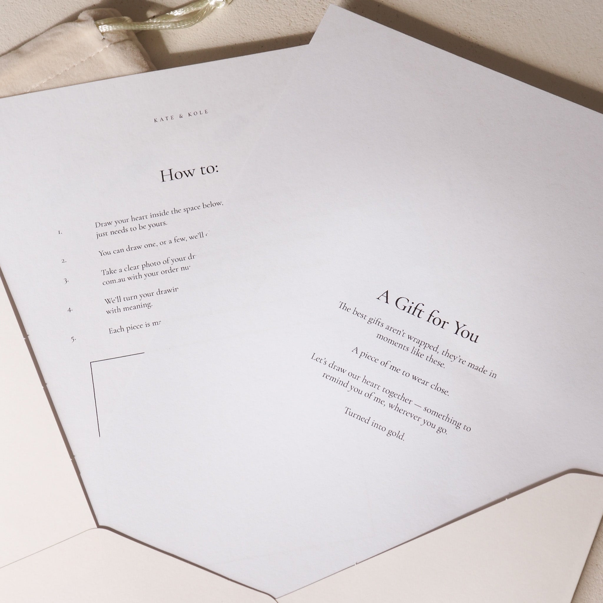 Greeting card with text and a small envelope on a light wooden surface