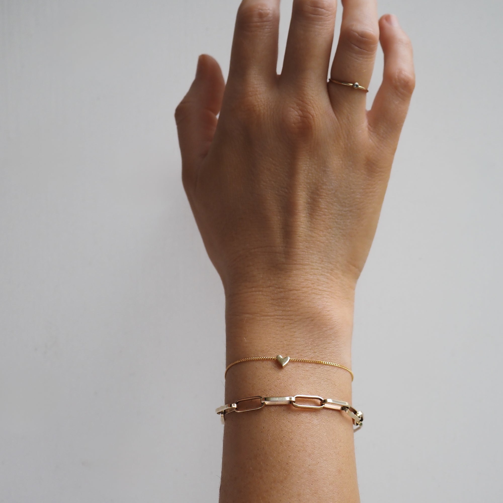 Hand wearing gold link bracelet