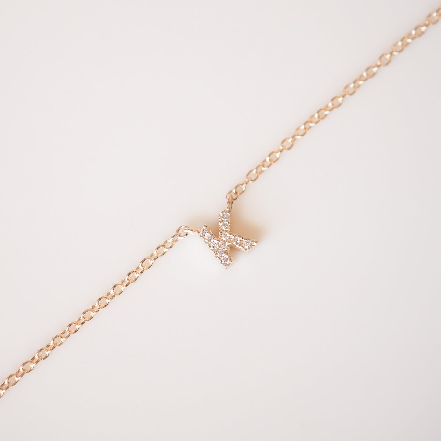 Gold diamond letter necklace on a cable chain