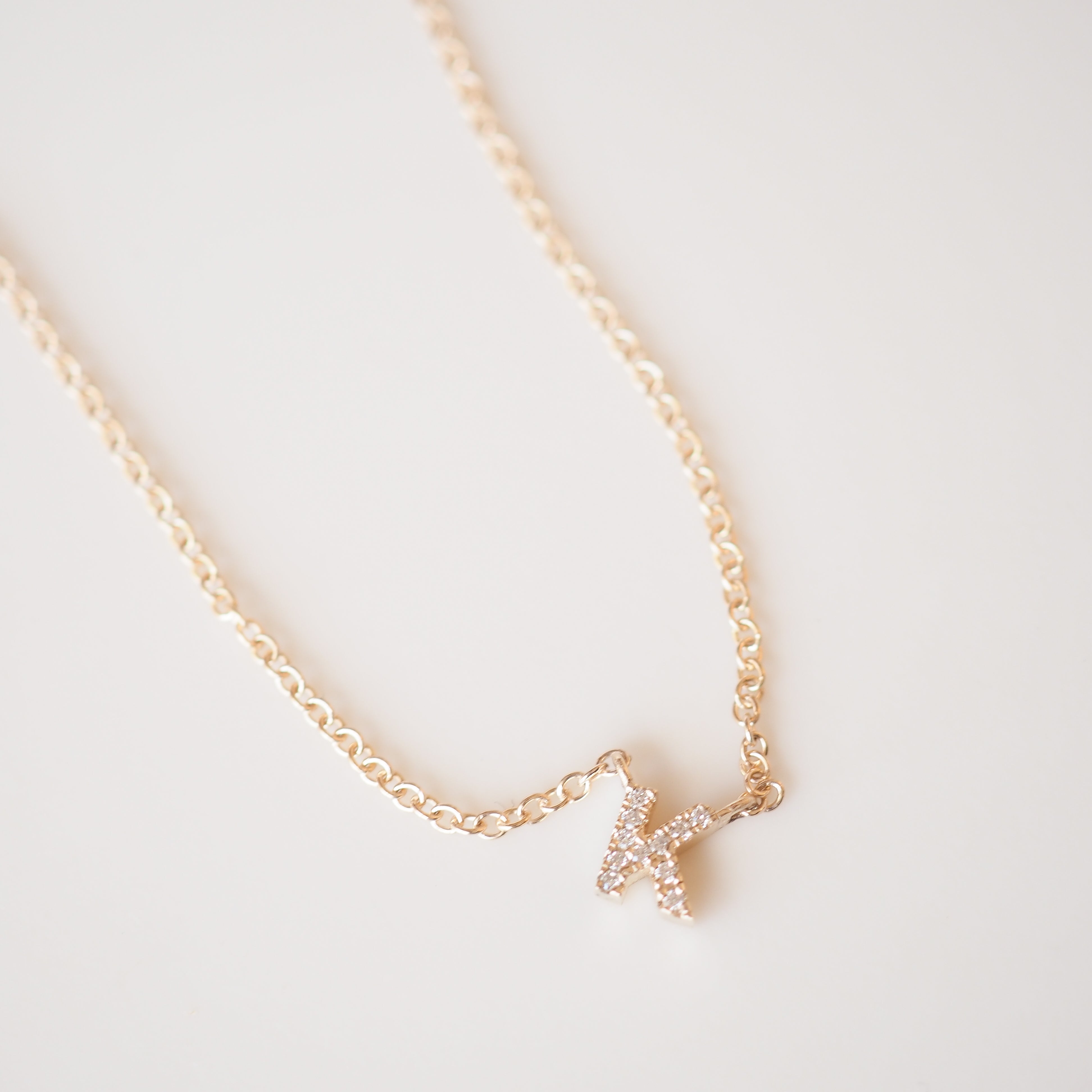 Gold diamond letter necklace on a cable chain