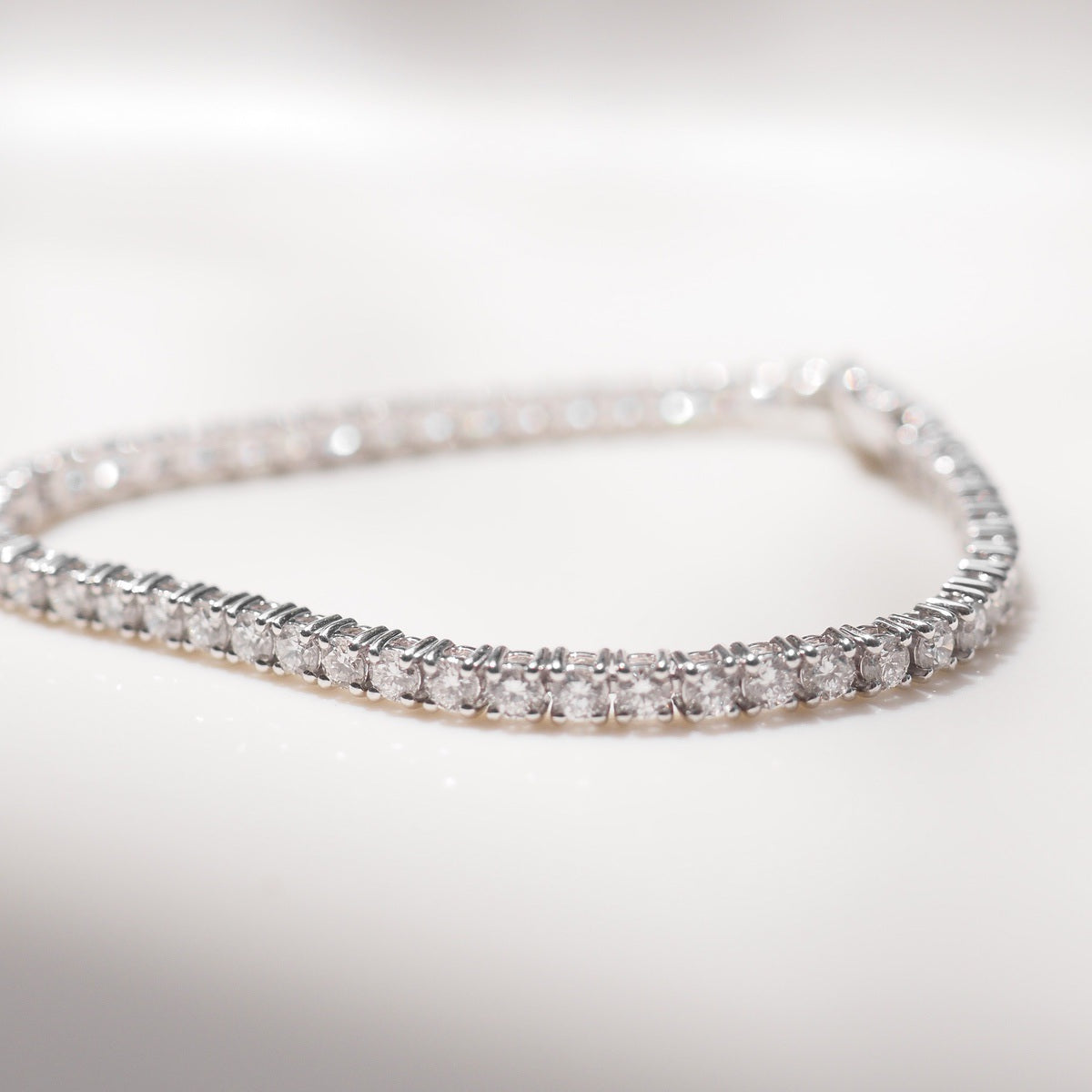 Close up of tennis bracelet on beige background