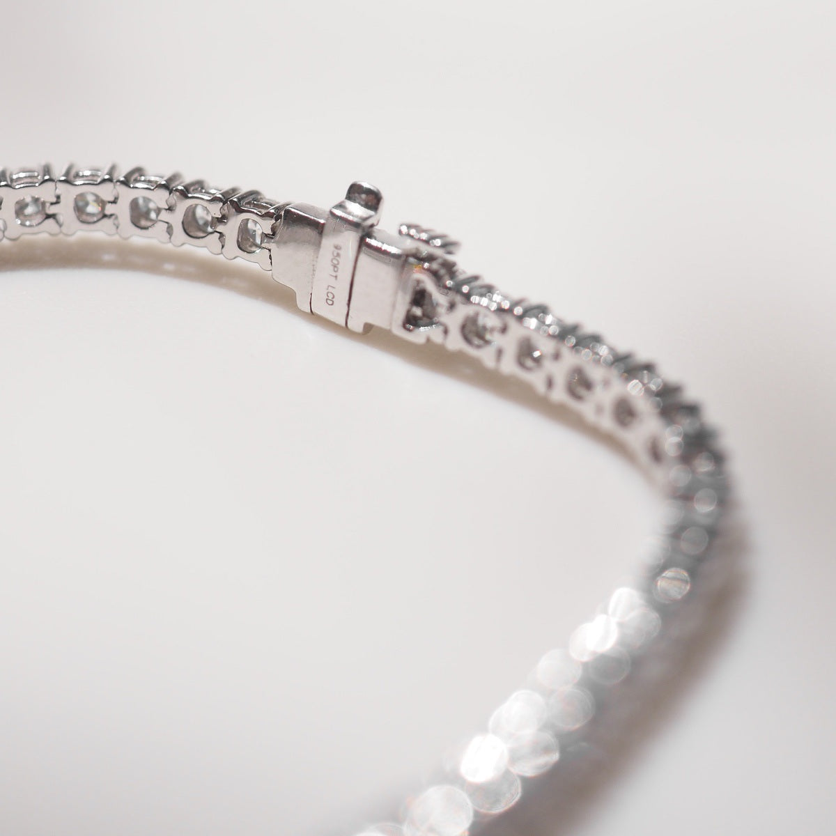 Close up of tennis bracelet on beige background