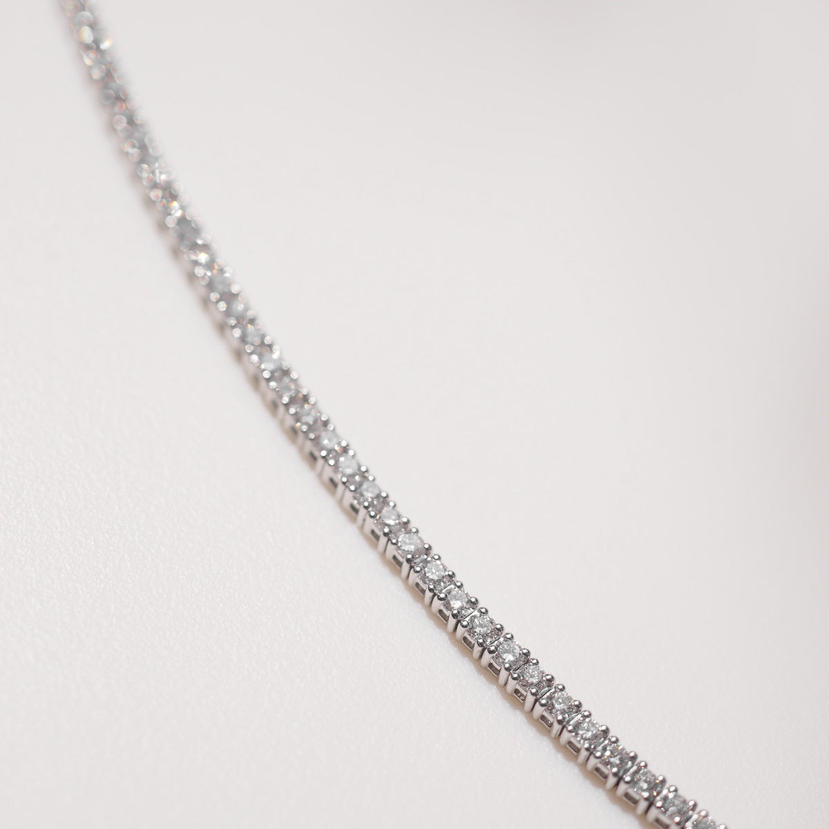 Close up of tennis bracelet on beige background