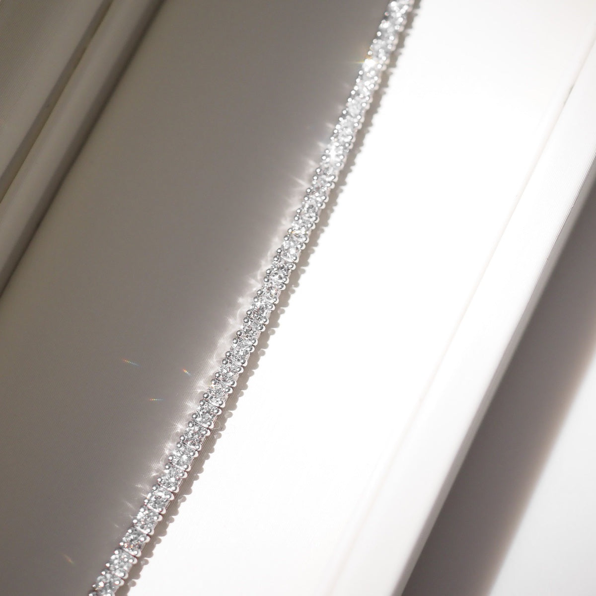 Close up of tennis bracelet on beige background