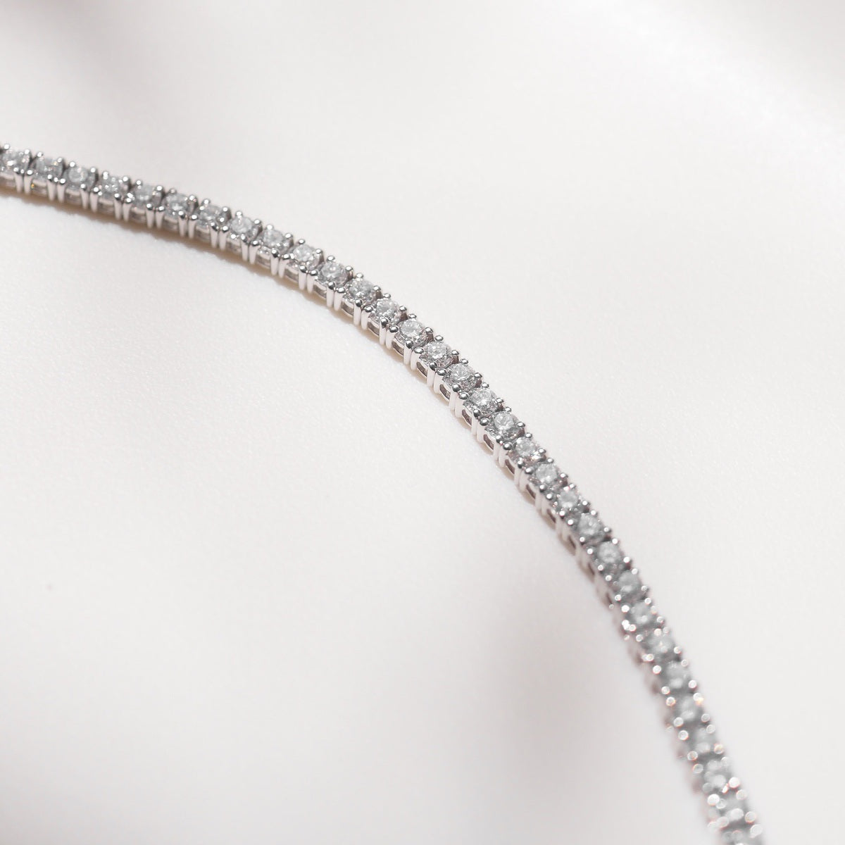 Close up of tennis bracelet on beige background