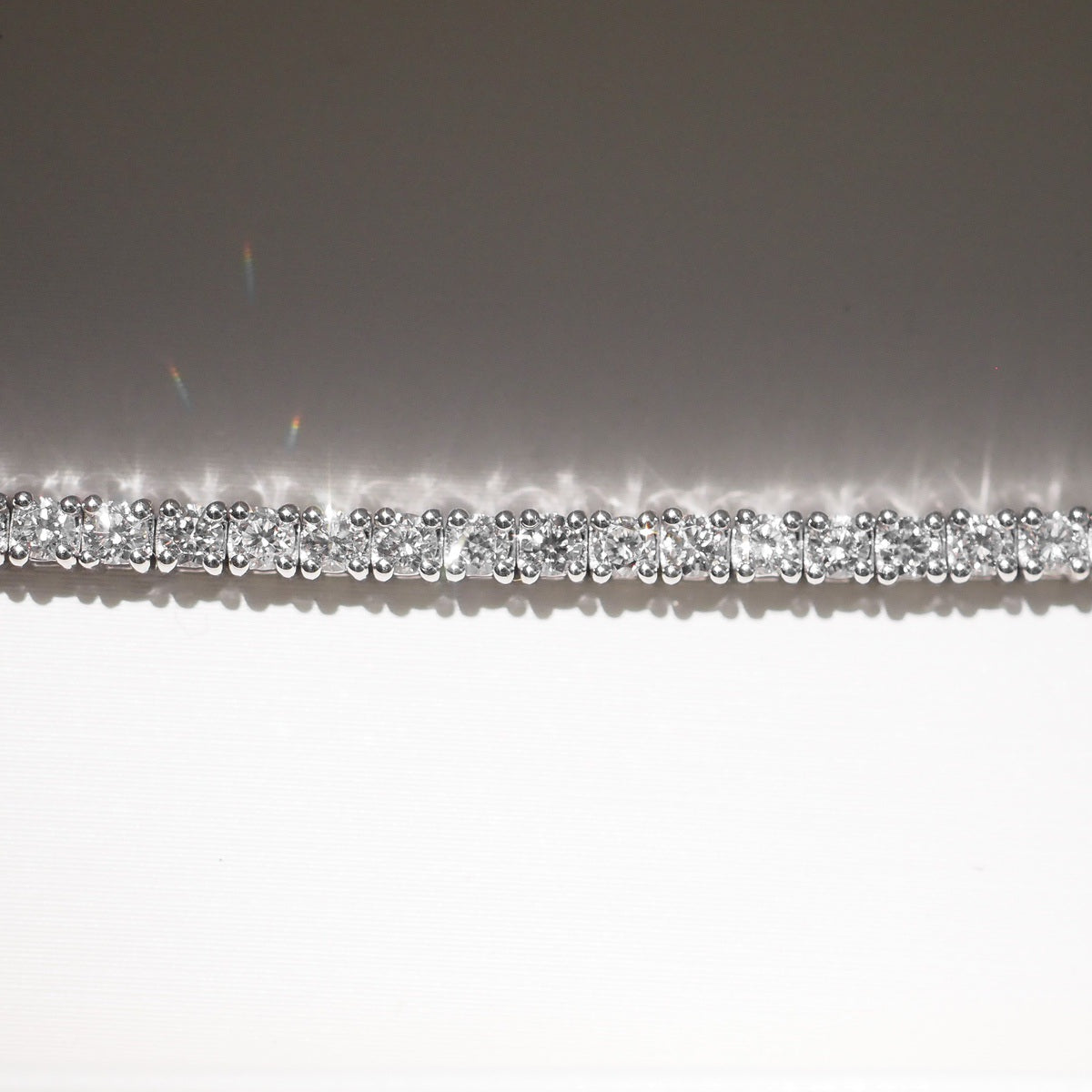 Close up of tennis bracelet on beige background