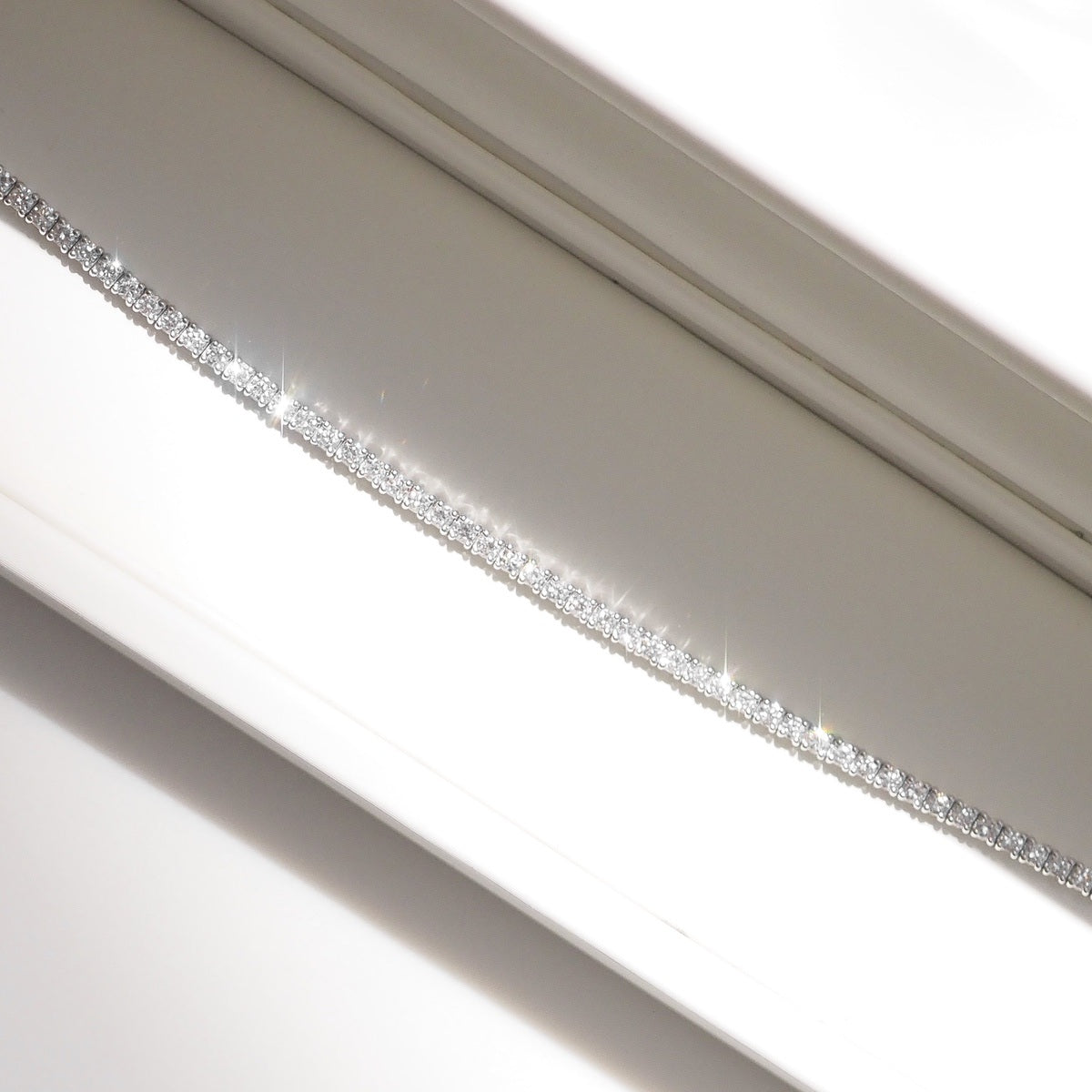 Close up of tennis bracelet on beige background
