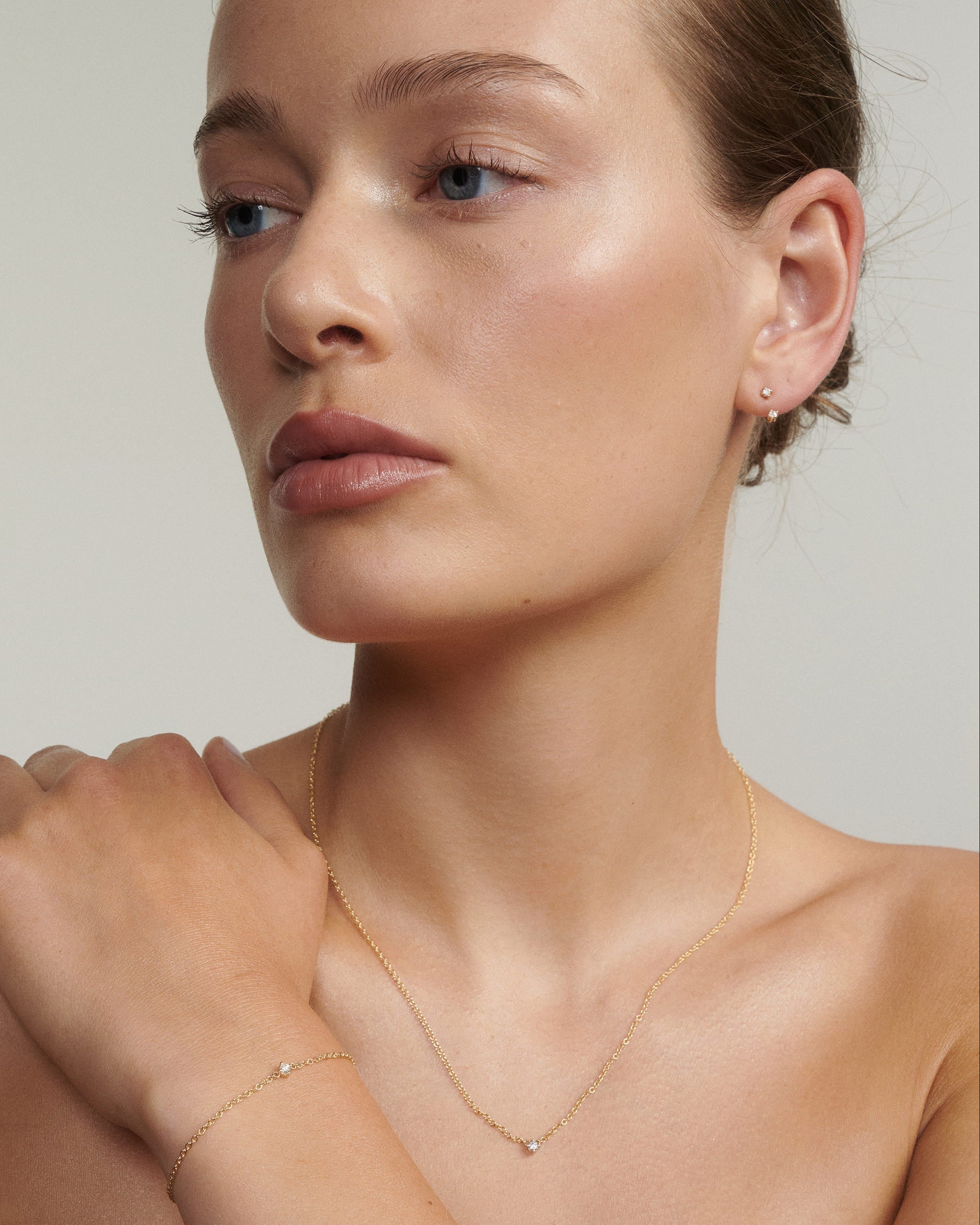 Woman wearing The Birthstone Necklace, Bracelet, Stud & Jacket 