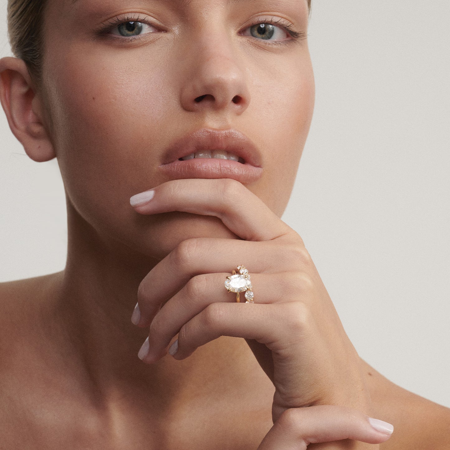 Close-up of a woman's hand wearing a diamond ring on a neutral background

[text overlay: Our 3mm Arraya paired with our 3ct Clara]