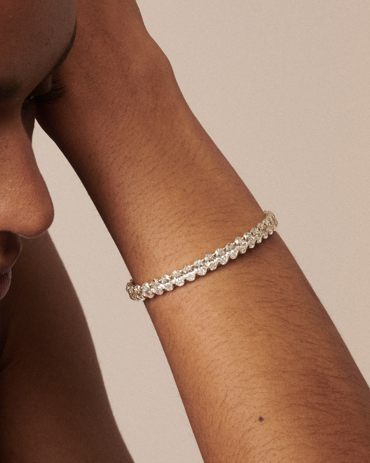 Oval-cut lab-grown diamond bracelet on forearm with sparkling stone row