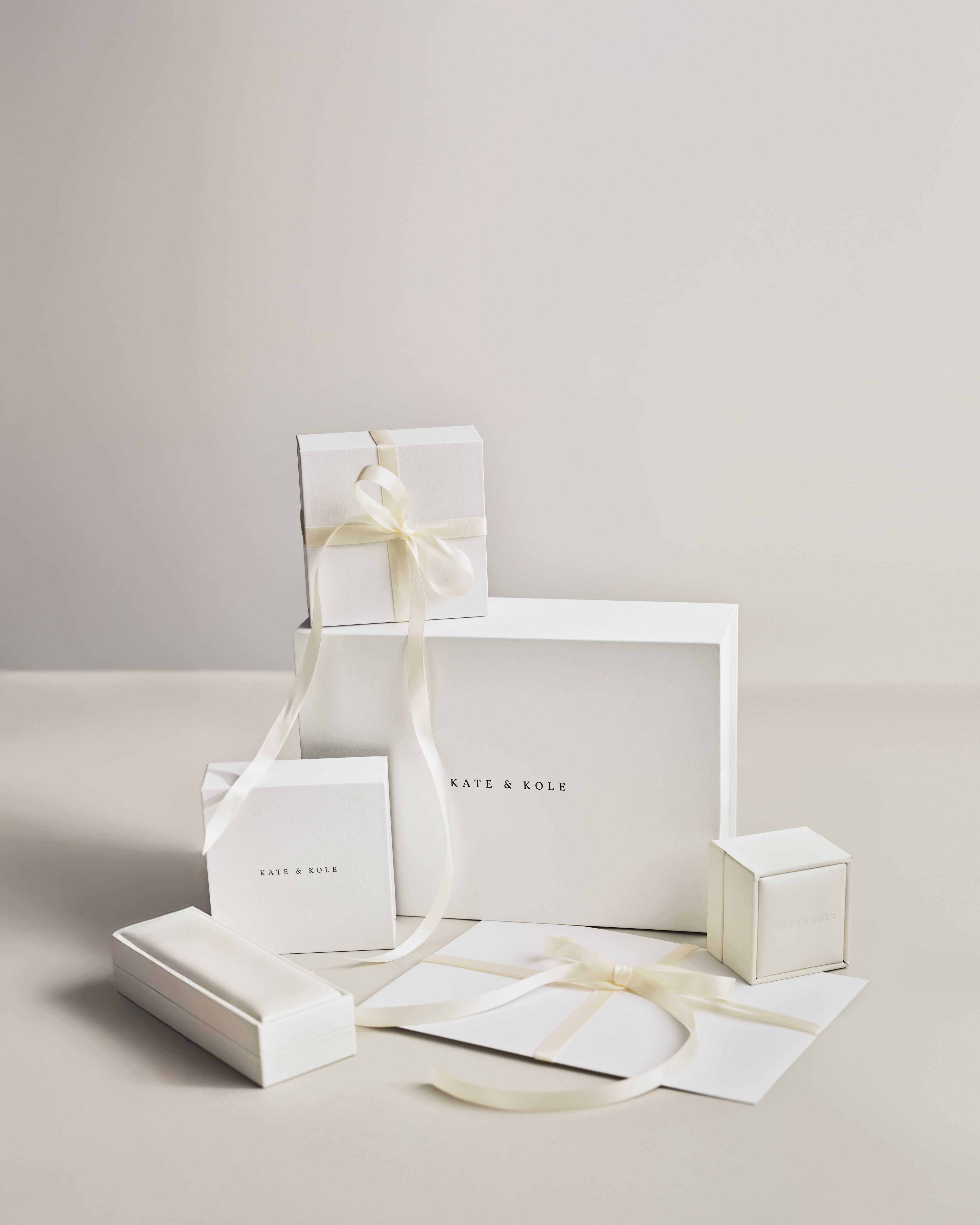 Kate & Kole gift packaging and white boxes, displayed on a white background.