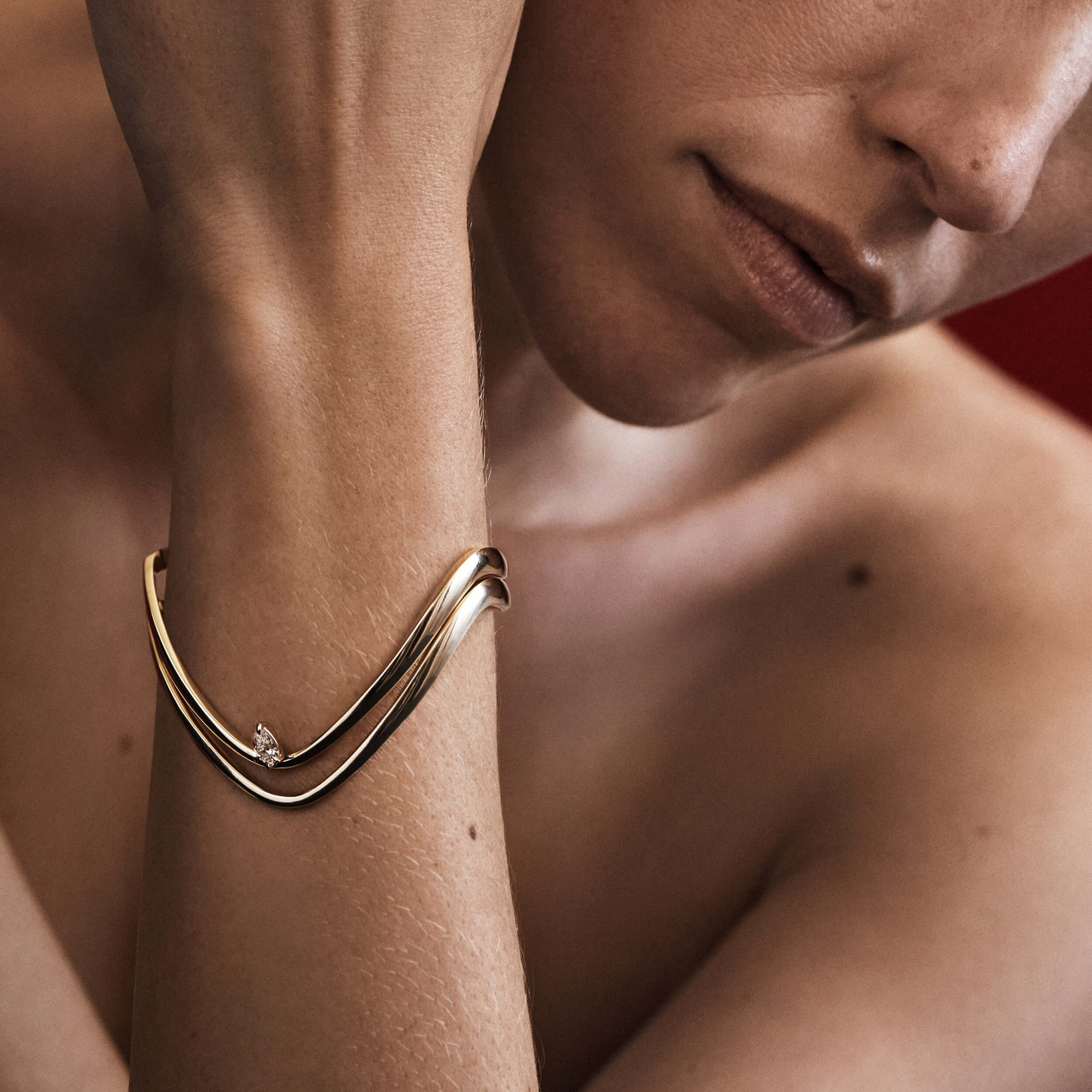 Gold bracelet on a wrist with a blurred background