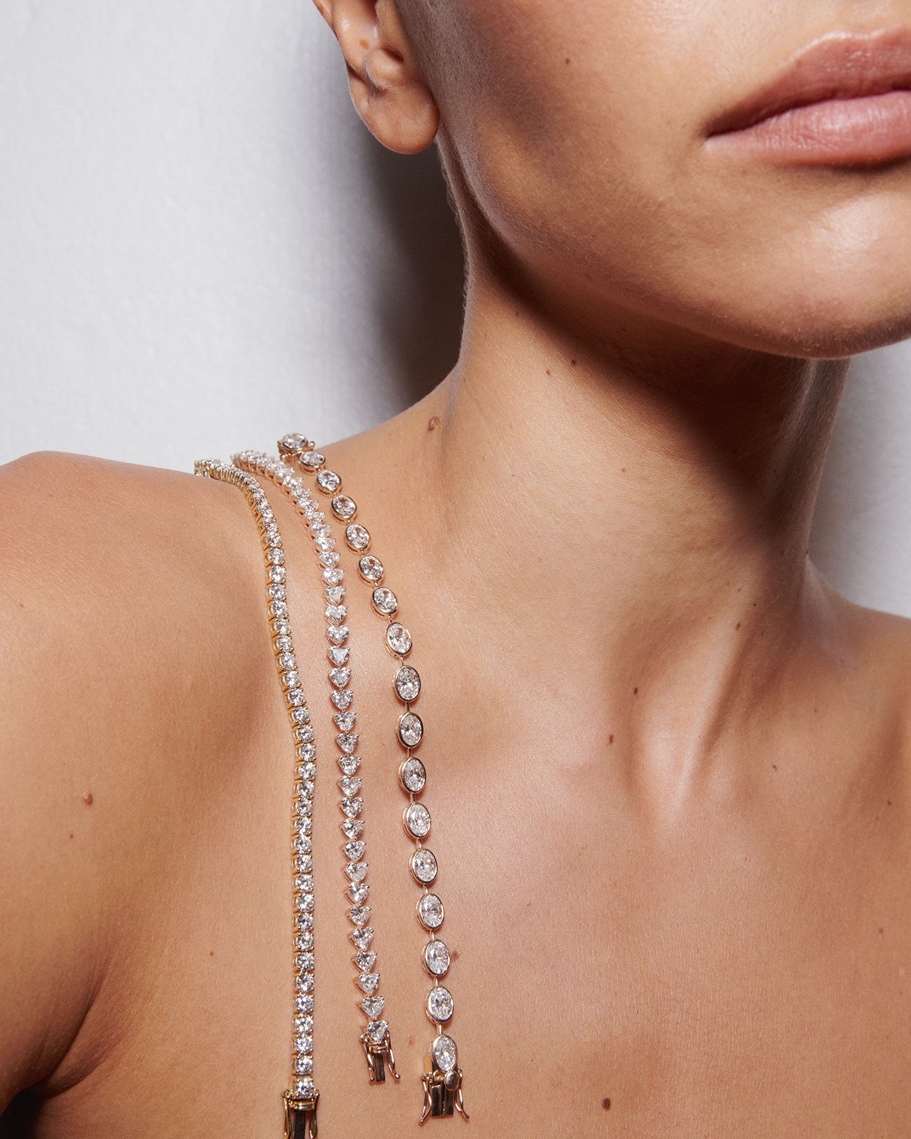 Model wearing Kate & Kole lab-grown diamond tennis bracelets draped across the shoulder, photographed in natural light.