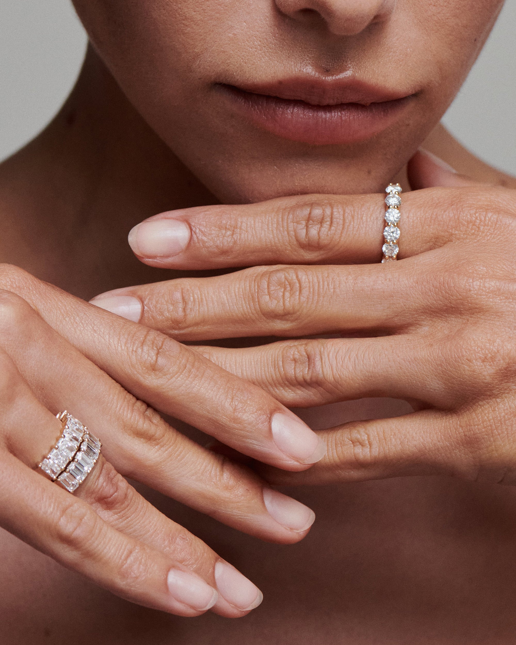 Close-up of hands adorned with Kate & Kole lab-grown diamond rings, showcasing elegant craftsmanship and minimal design.