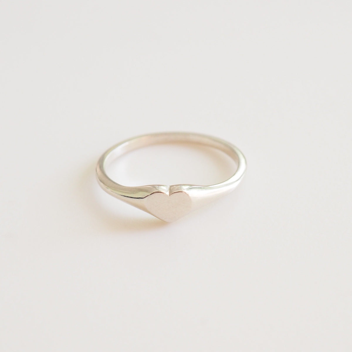 Silver ring on a light gray background