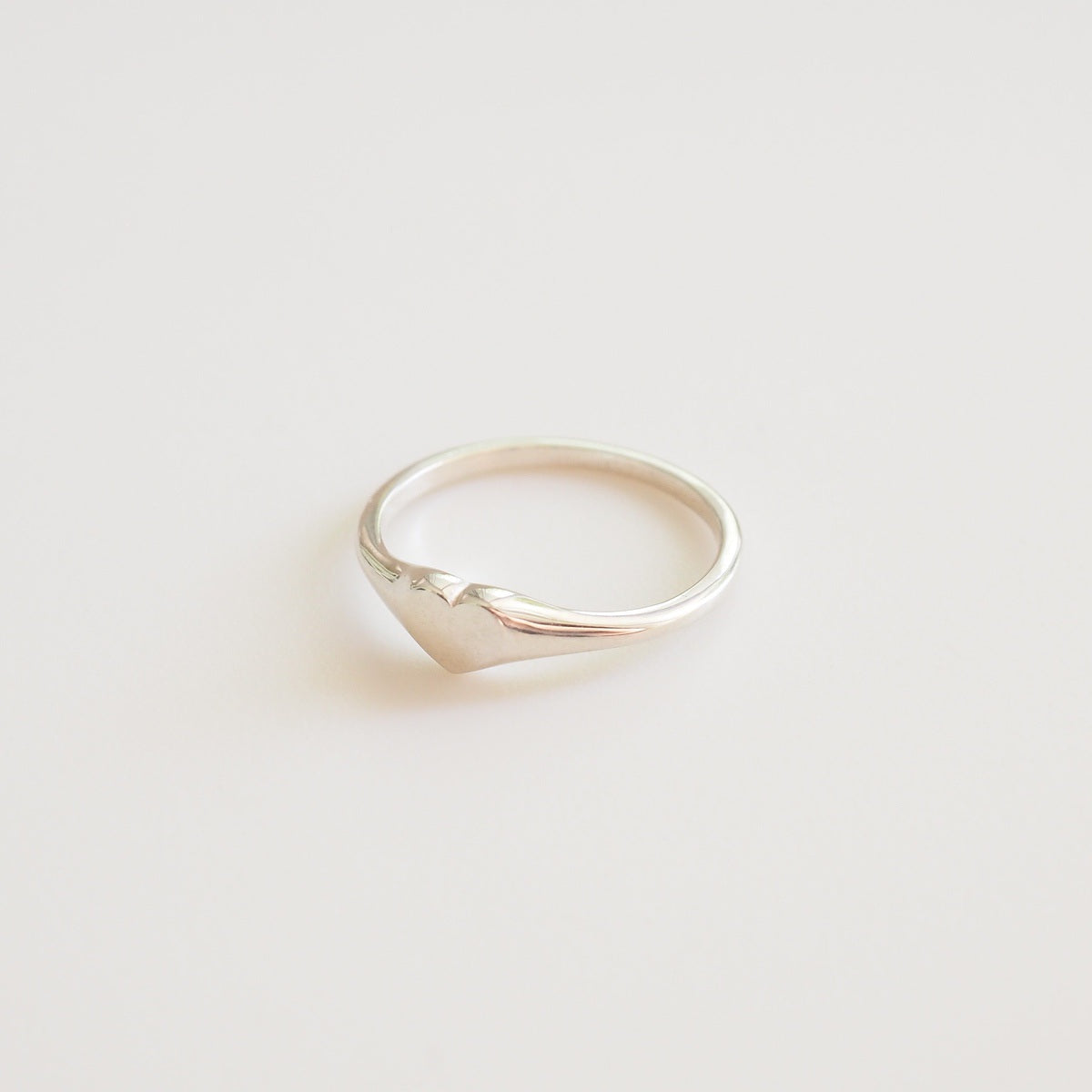 Silver ring on a light beige background