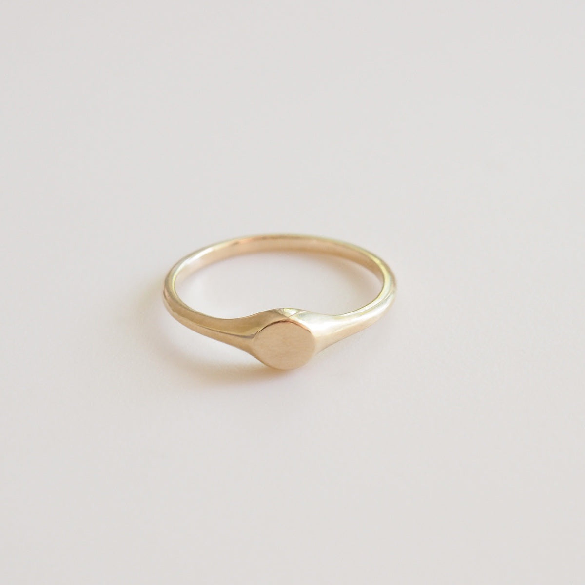 Gold ring on a light gray background