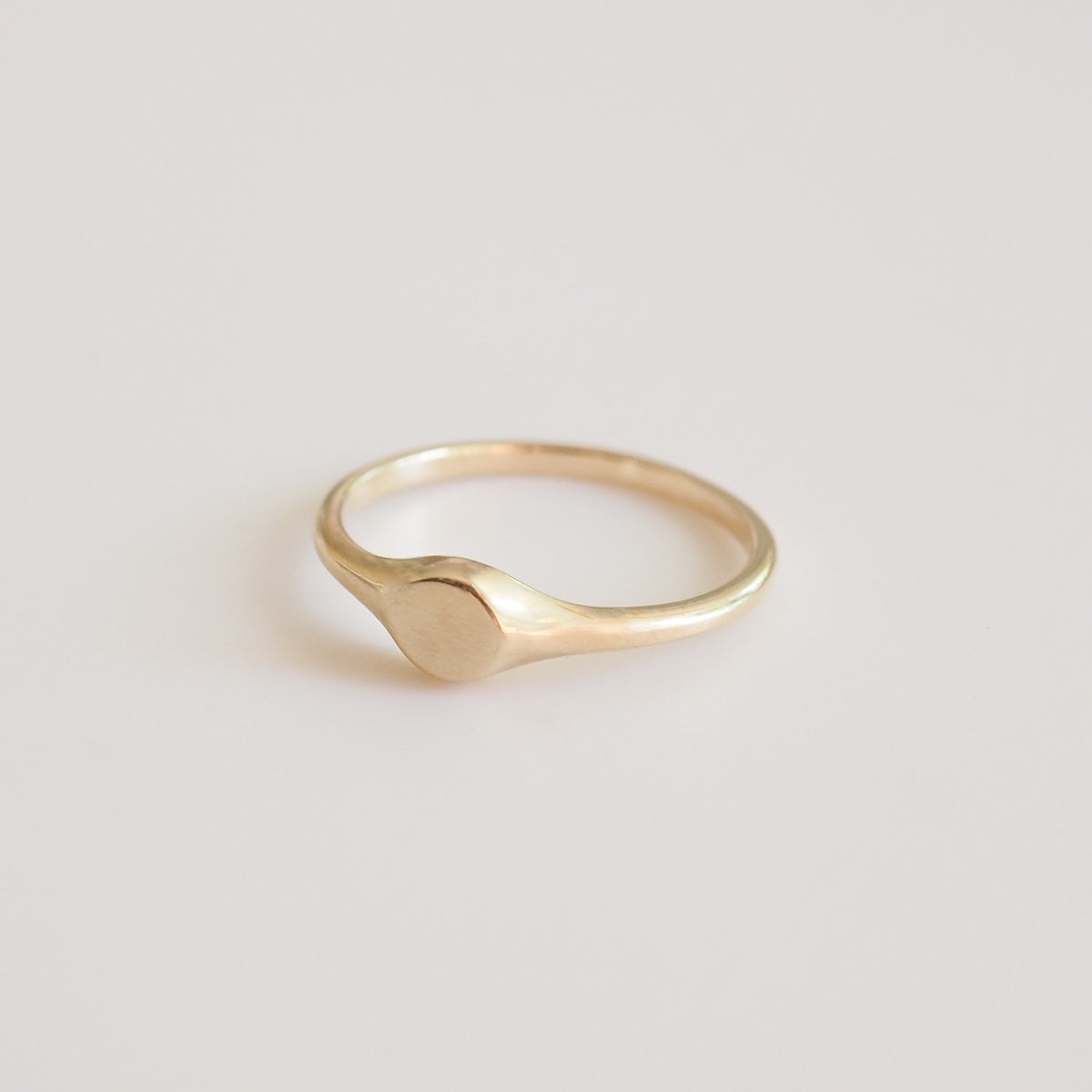 Gold ring on a light beige background